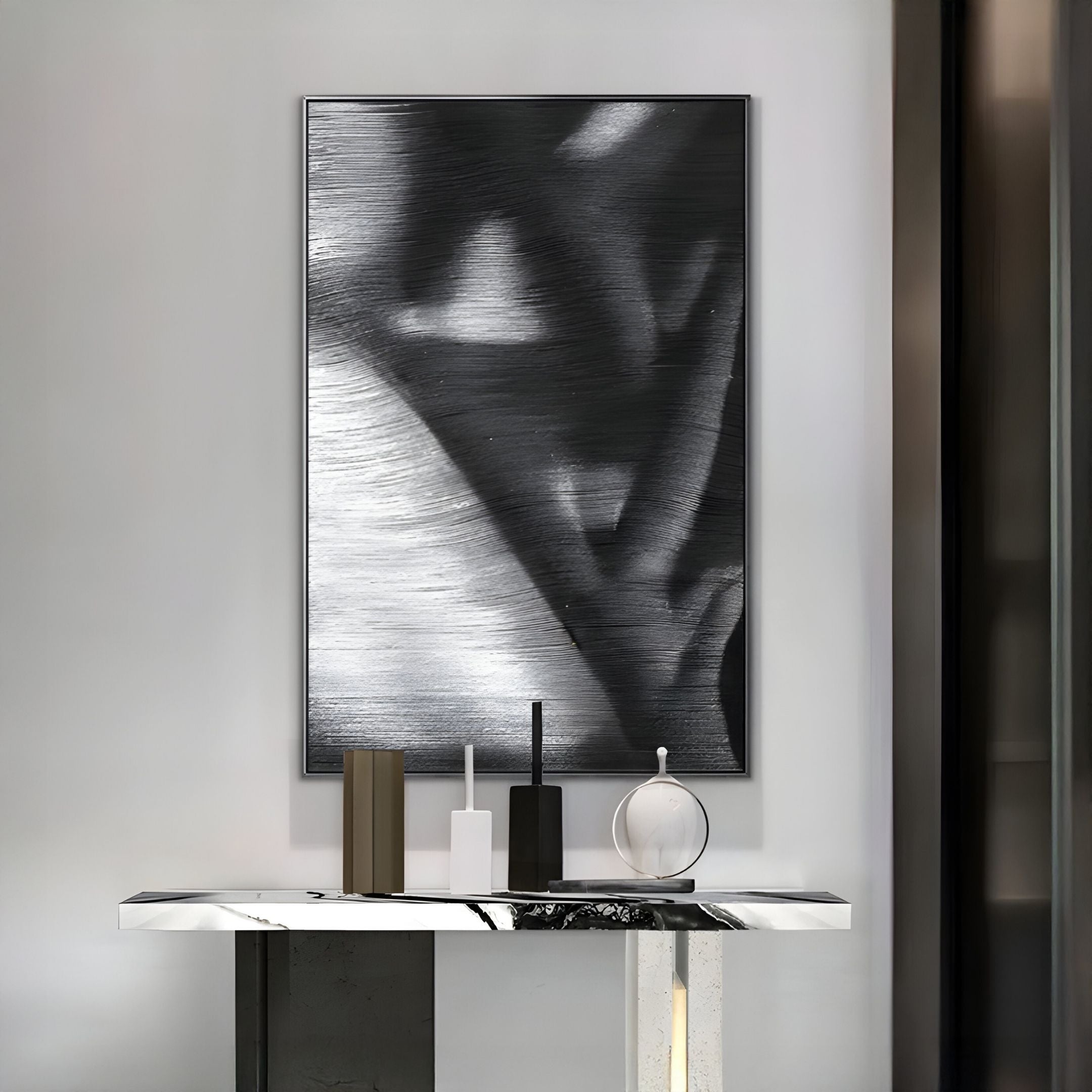 A modern console table with marble top displays minimalist decor beneath the Rivara Obsidian Flow Hand-Painted Rope 3D Wall Art by Giant Sculptures, perfectly complementing sleek modern monochrome interiors.