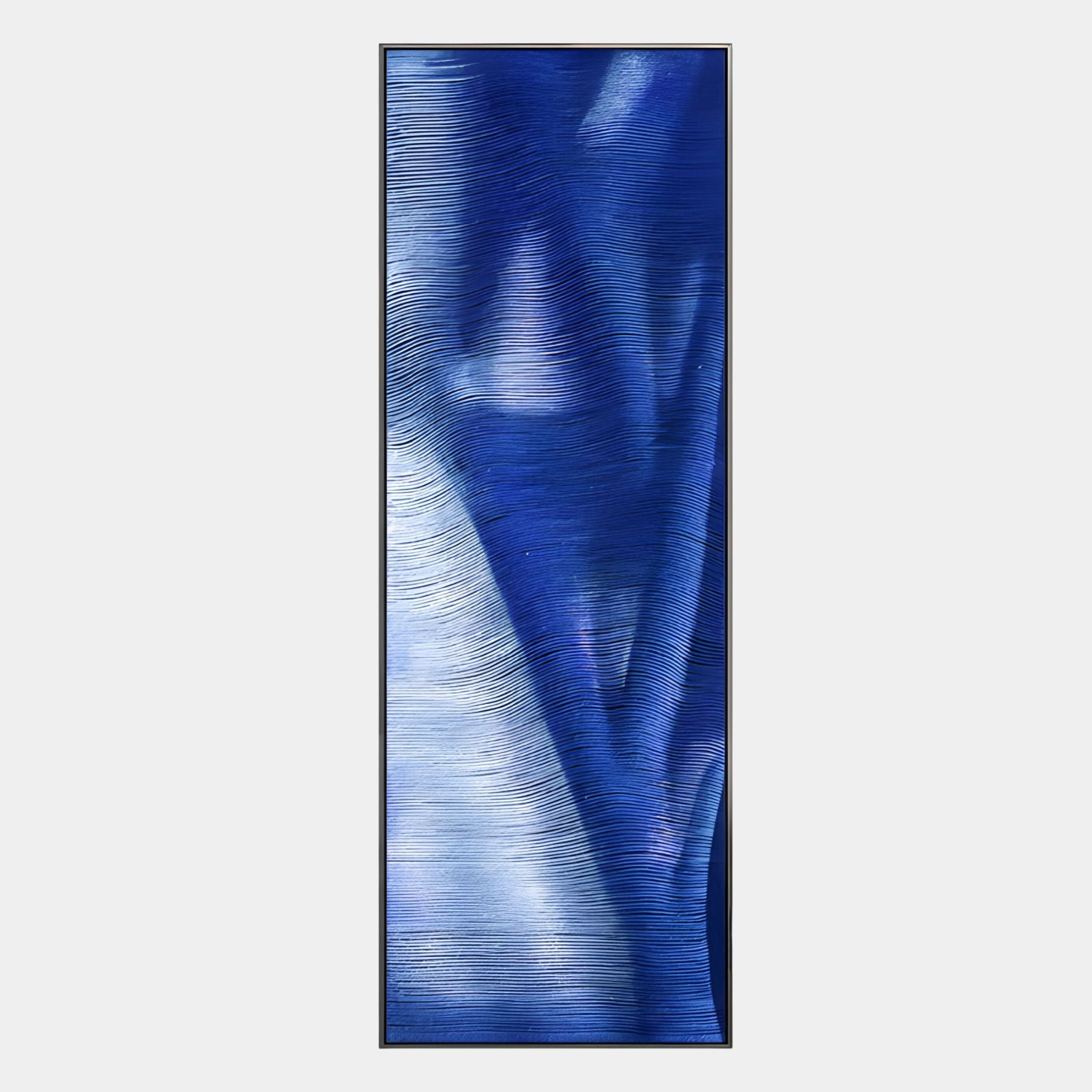 The Rivara Cobalt Wave Vertical Hand-Painted Rope 3D Wall Art by Giant Sculptures features horizontal textured blue and white lines in a tall, narrow frame—ideal for modern luxury interiors as eye-catching vertical wall décor.