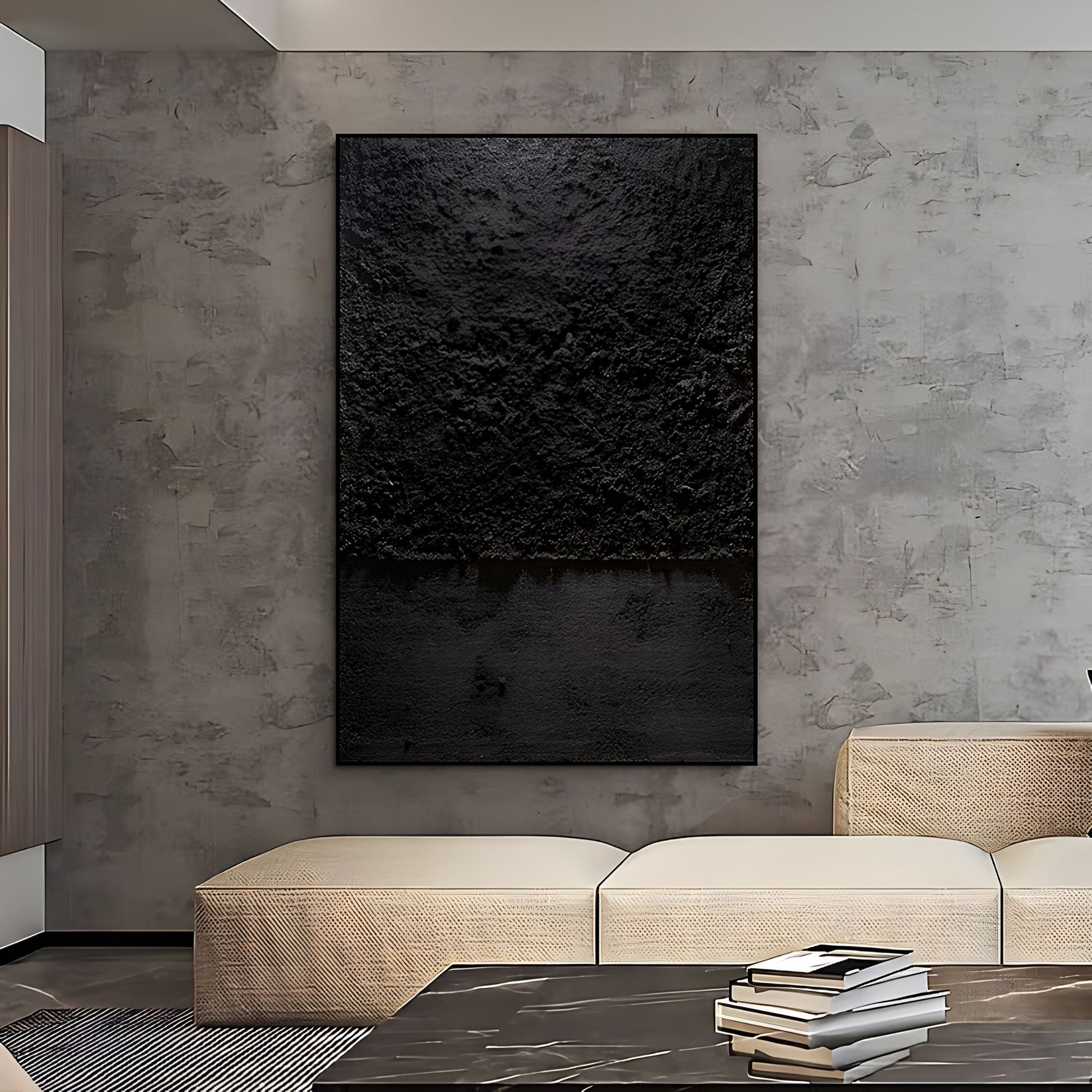 A modern living room features textured gray walls, beige seating, a dark marble coffee table with books, and Giant Sculptures’ Aeralune Midnight Black Textured Oil Painting 3D Wall Art as a striking focal point.