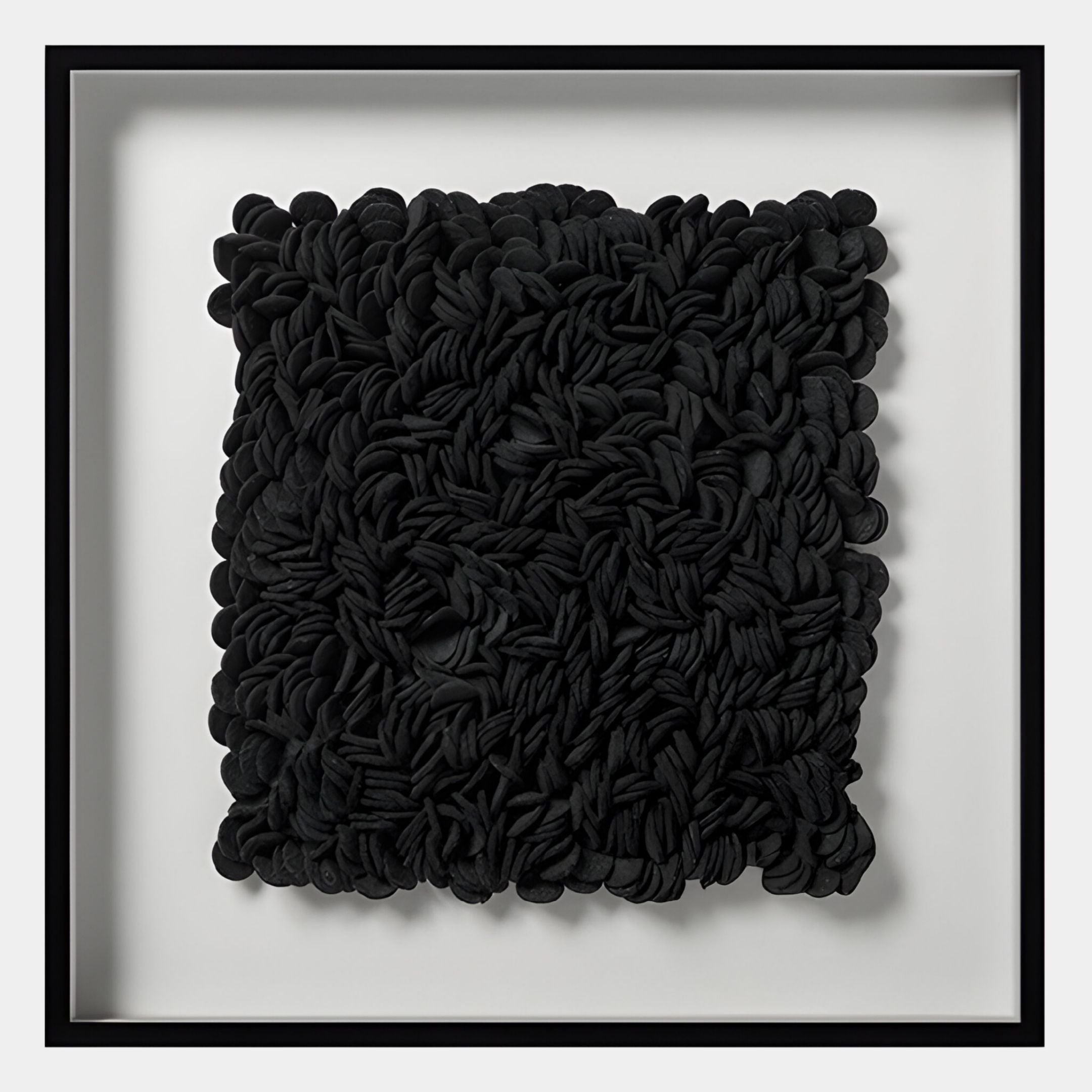 Petalus Black Layered Felt 3D Wall Art by Giant Sculptures features an abstract, textured arrangement of densely layered black felt pieces in a square black frame against a white background.