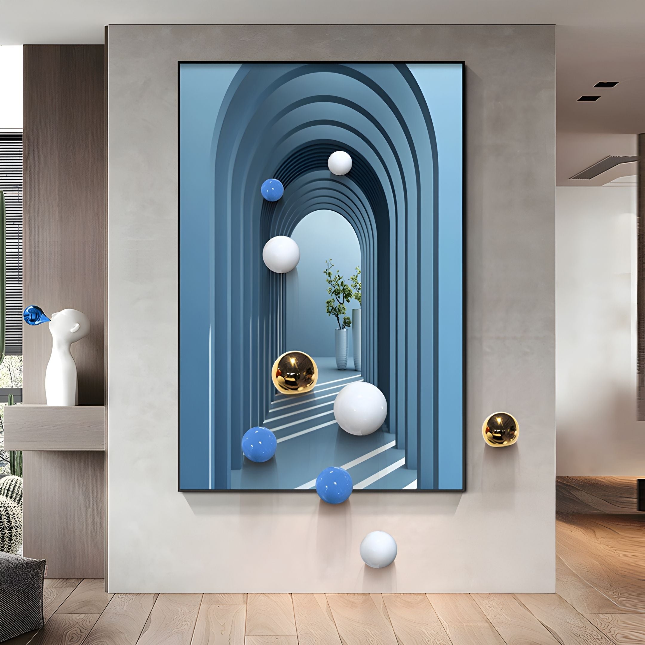 A modern interior features the Vaultis Blue Archway 3D Wall Art With Metal Balls by Giant Sculptures, showcasing blue and white arches with blue, white, and gold metal spheres. A white sculpture and decor on the shelf complete the contemporary look.