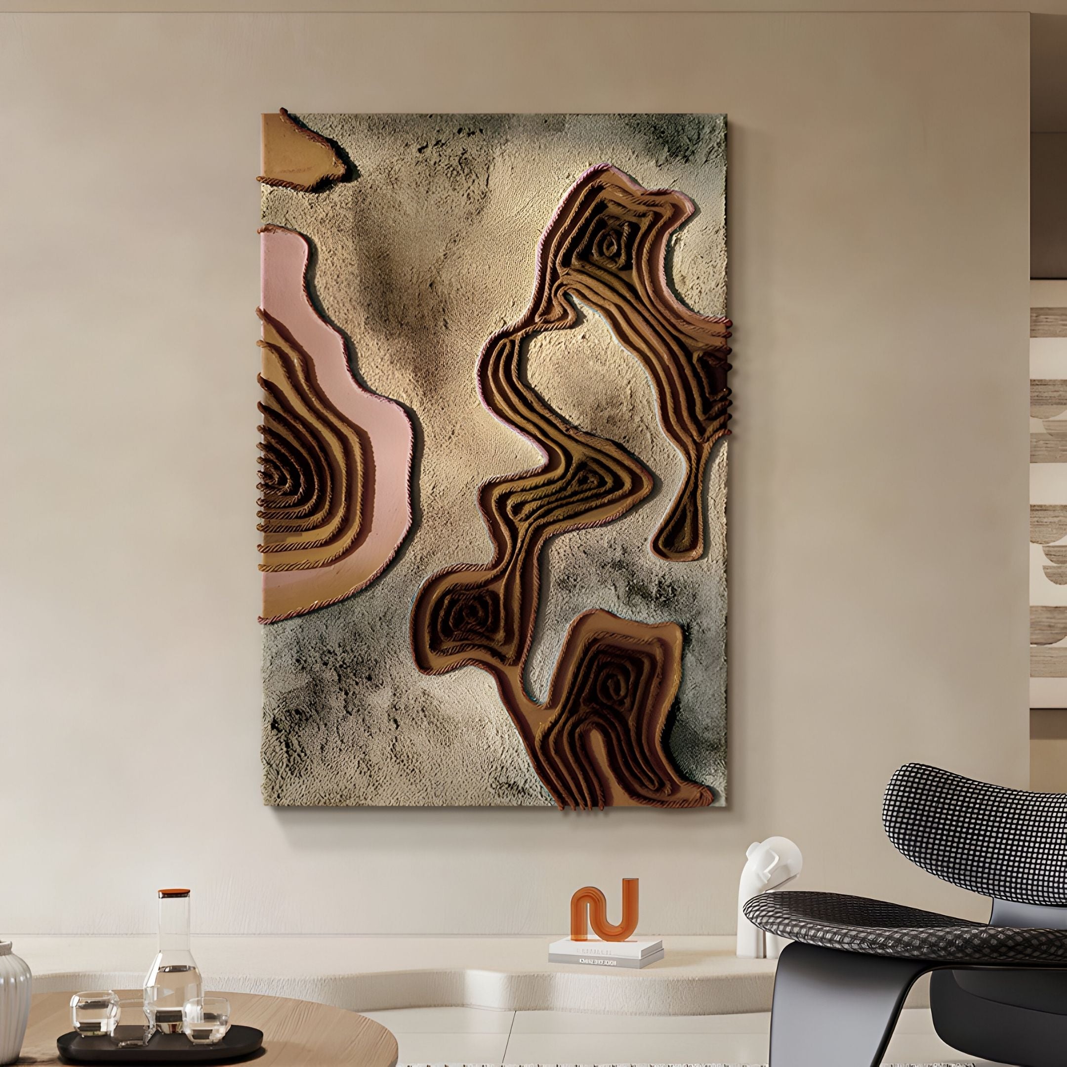 The Terracore Earth Brown Contour Relief Abstract 3D Wall Art by Giant Sculptures, featuring wavy cream, brown, and pink layers, hangs on a beige wall above a white table with a modern chair and minimalist decor.