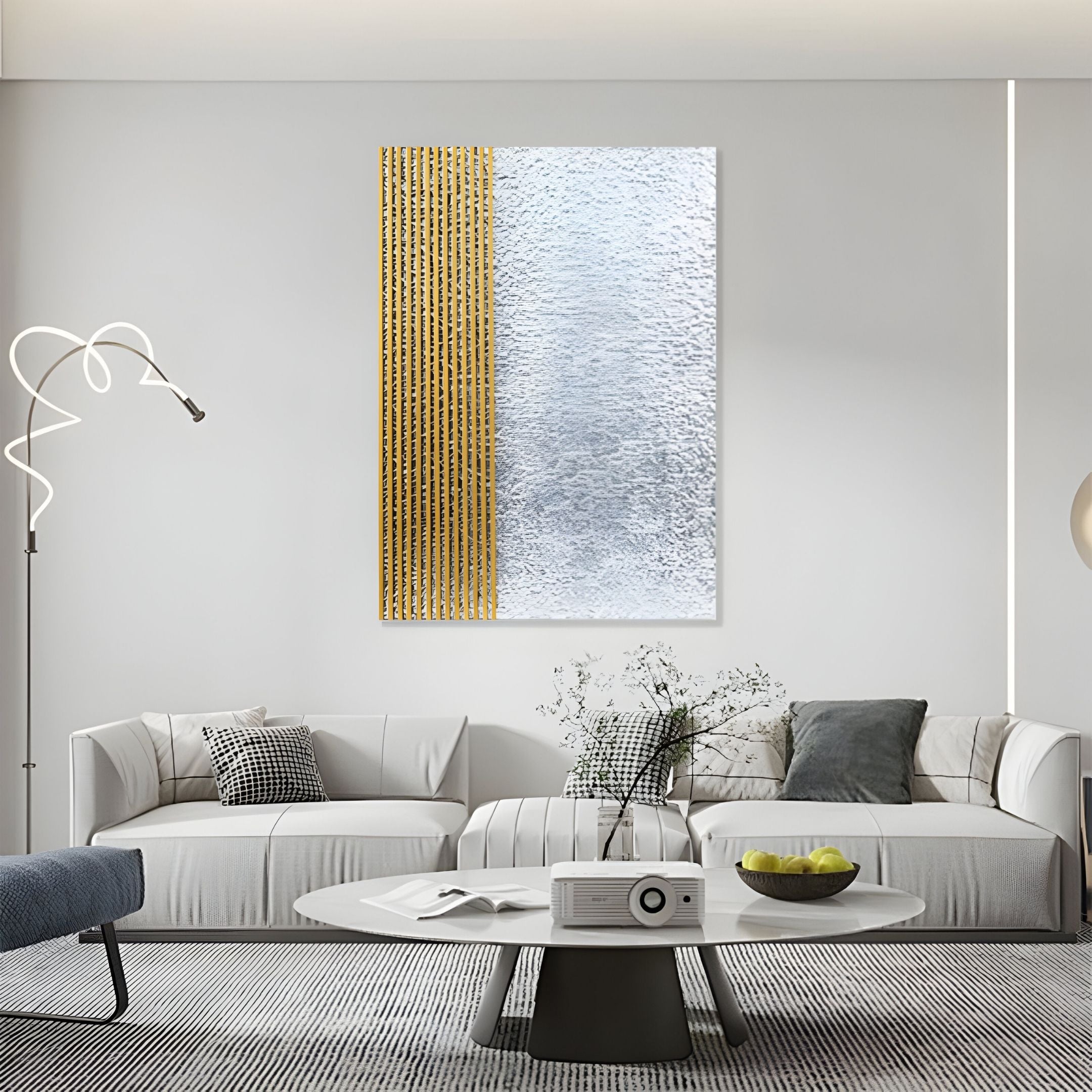 A modern living room with two white sofas, a round coffee table topped with a projector and green apples, and Giant Sculptures' Metallure Gold Linear Textured Acrylic Silver Foil 3D Wall Art as the striking focal point on the wall.