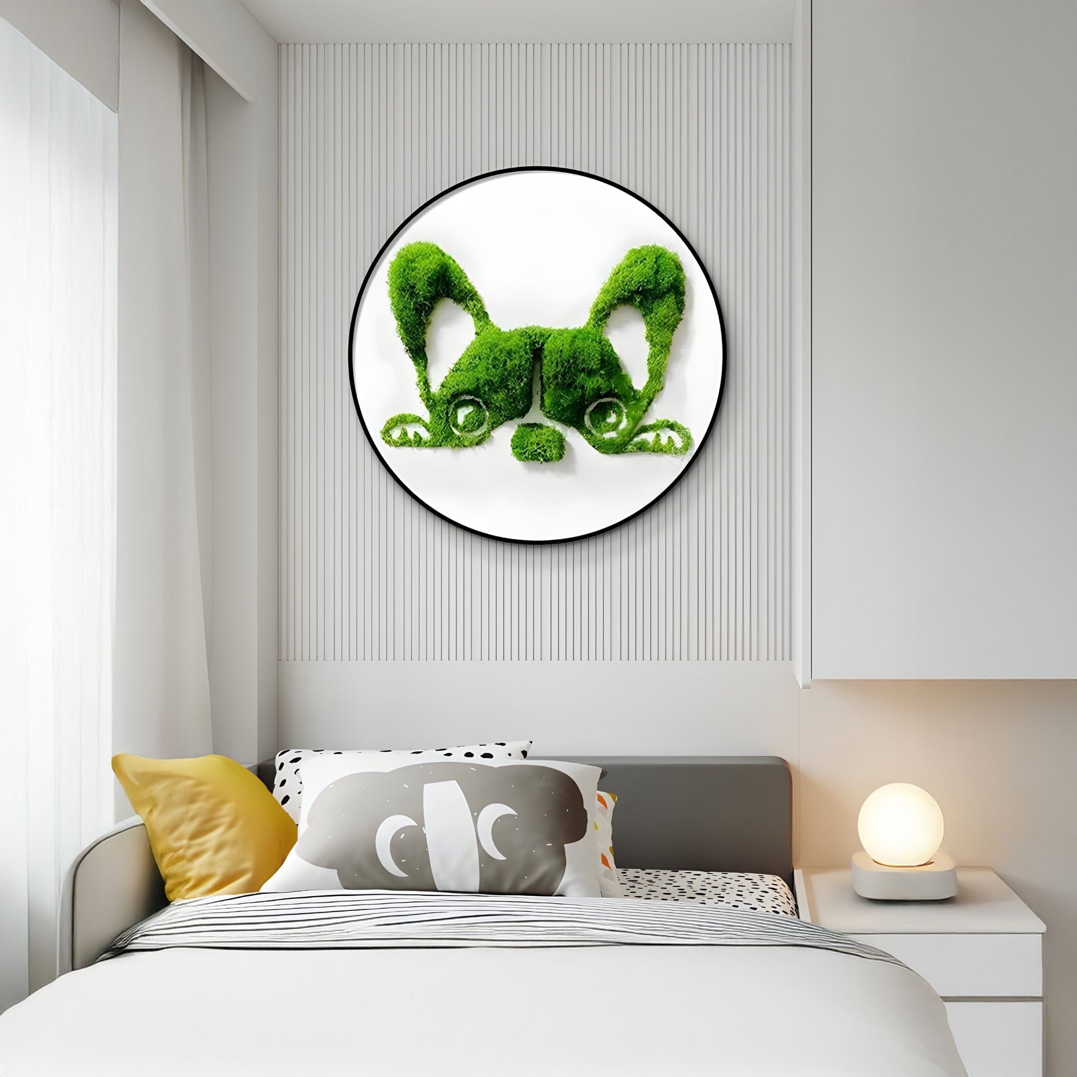 A modern bedroom features a bed with yellow and black pillows, a round glowing lamp on a white nightstand, and Giant Sculptures’ Verdifable Round Green Puppy Ears Moss 3D Wall Art above the bed.