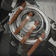 The Prestivo Cigar & Vintage Camera Framed Display Wall Art by Giant Sculptures features four brown cigars resting on a black-and-white vintage camera lens, creating a striking and unique decor piece.
