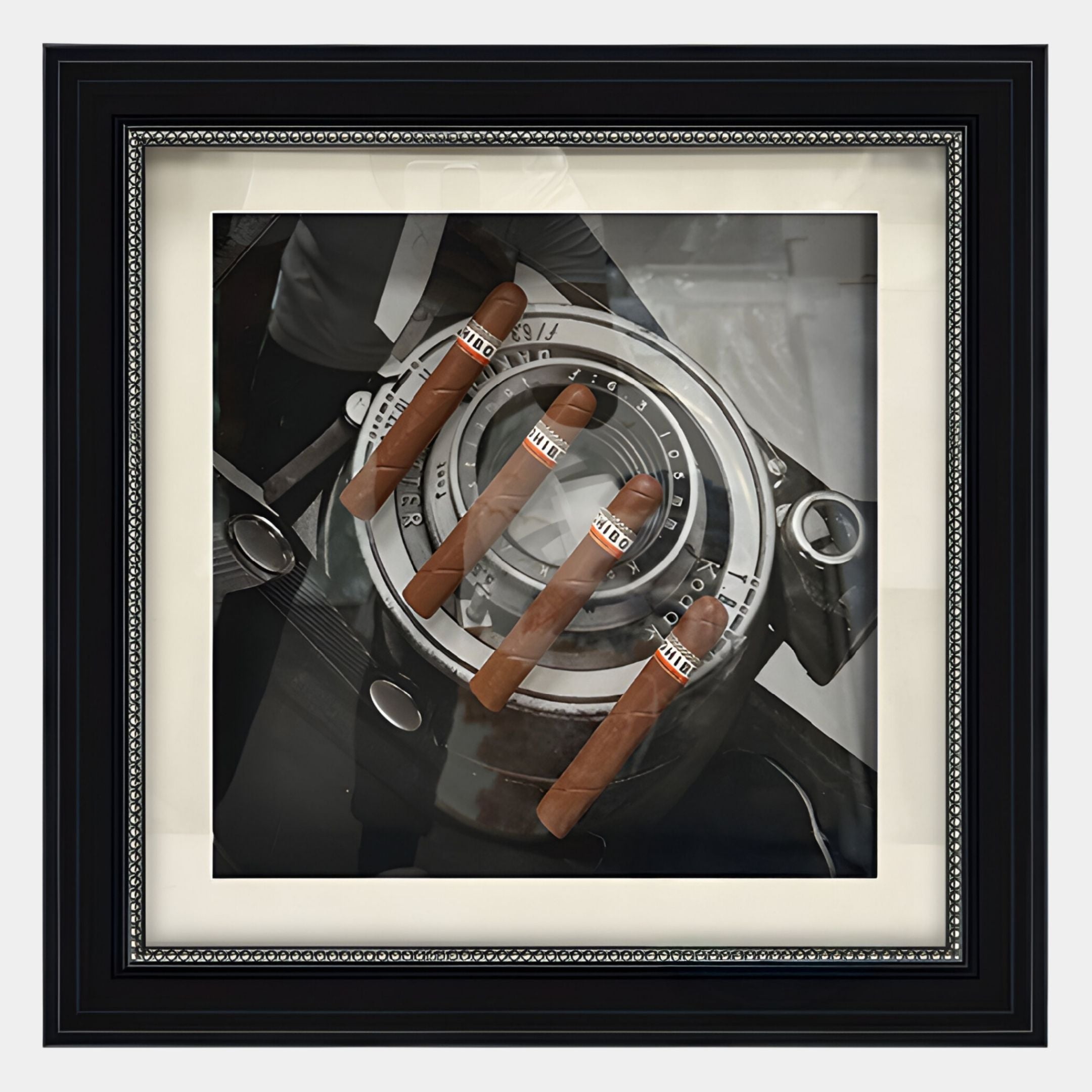 The Prestivo Cigar & Vintage Camera Framed Display Wall Art by Giant Sculptures features four COHIBA cigars on a vintage camera, with a reflected silhouette adding intrigue to this unique wall art piece.