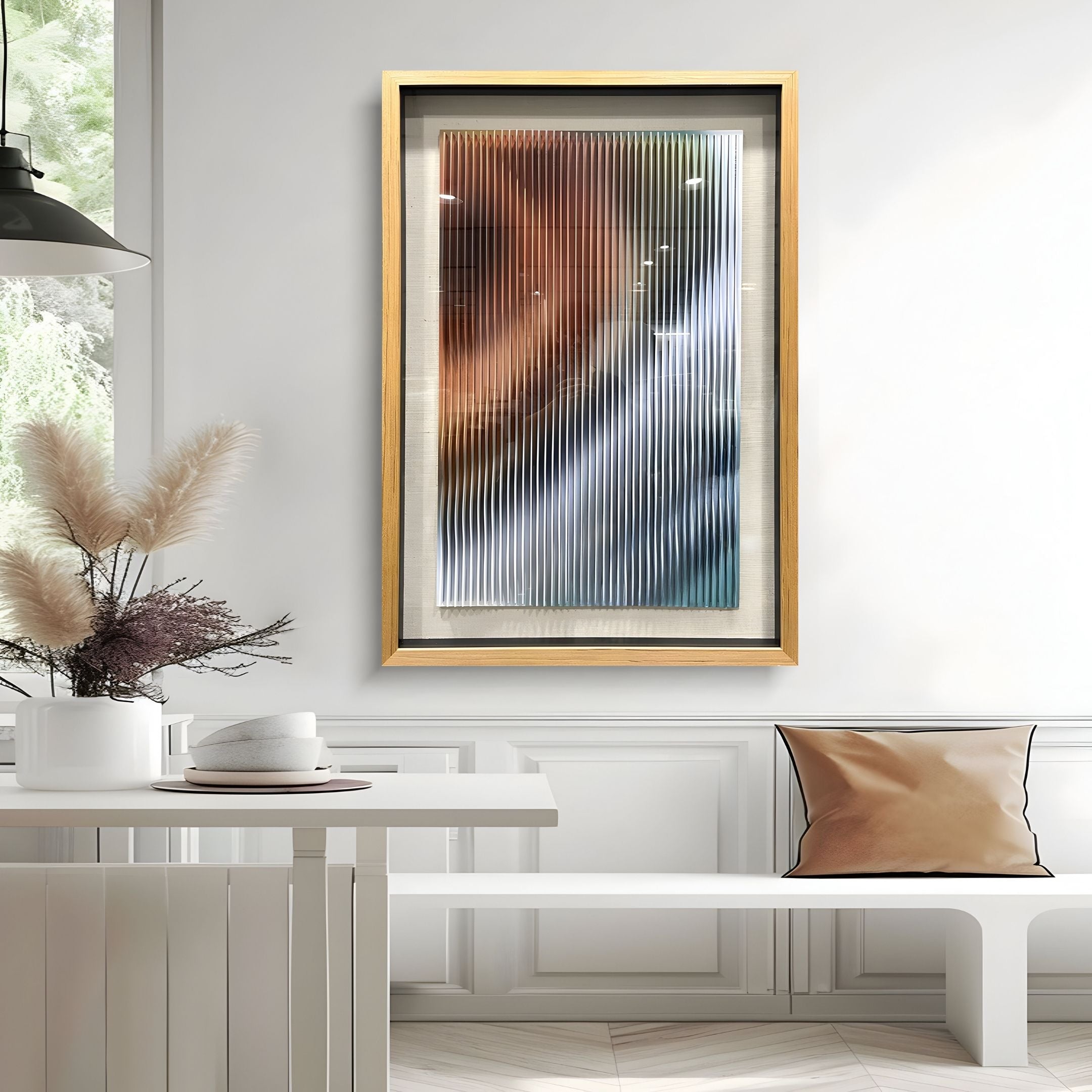 A modern interior features a white table, pampas grass in a vase, and Giant Sculptures' Lentari Amber & Frosted Silver Gradient Wood Carving 3D Wall Art, adding depth and elegance to the contemporary decor.