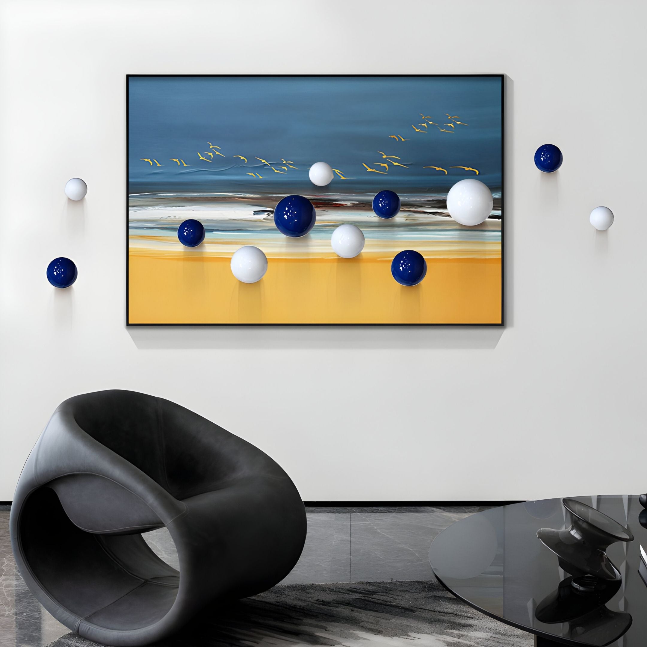A modern space showcases Giant Sculptures' Aerisphere Coastal Horizon 3D Wall Art, featuring birds, sky, sea, and yellow sand with blue and white metal balls, complemented by a sculptural black chair and a glass table.