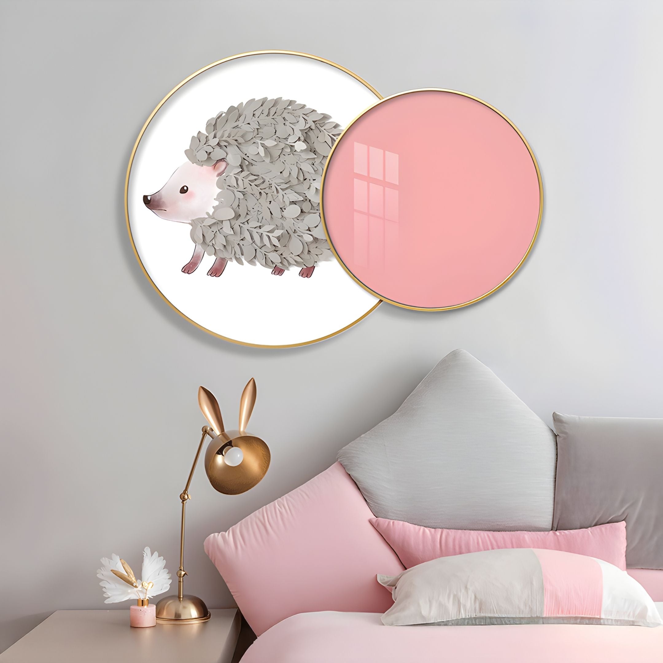 A bedroom features Giant Sculptures’ Blossomkin Pink Petal Hedgehog Kids 3D Wall Art as playful nursery decor, with the hedgehog partly tucked behind a pink circle, paired with pastel pink-and-gray bedding and a gold bunny-ear lamp.
