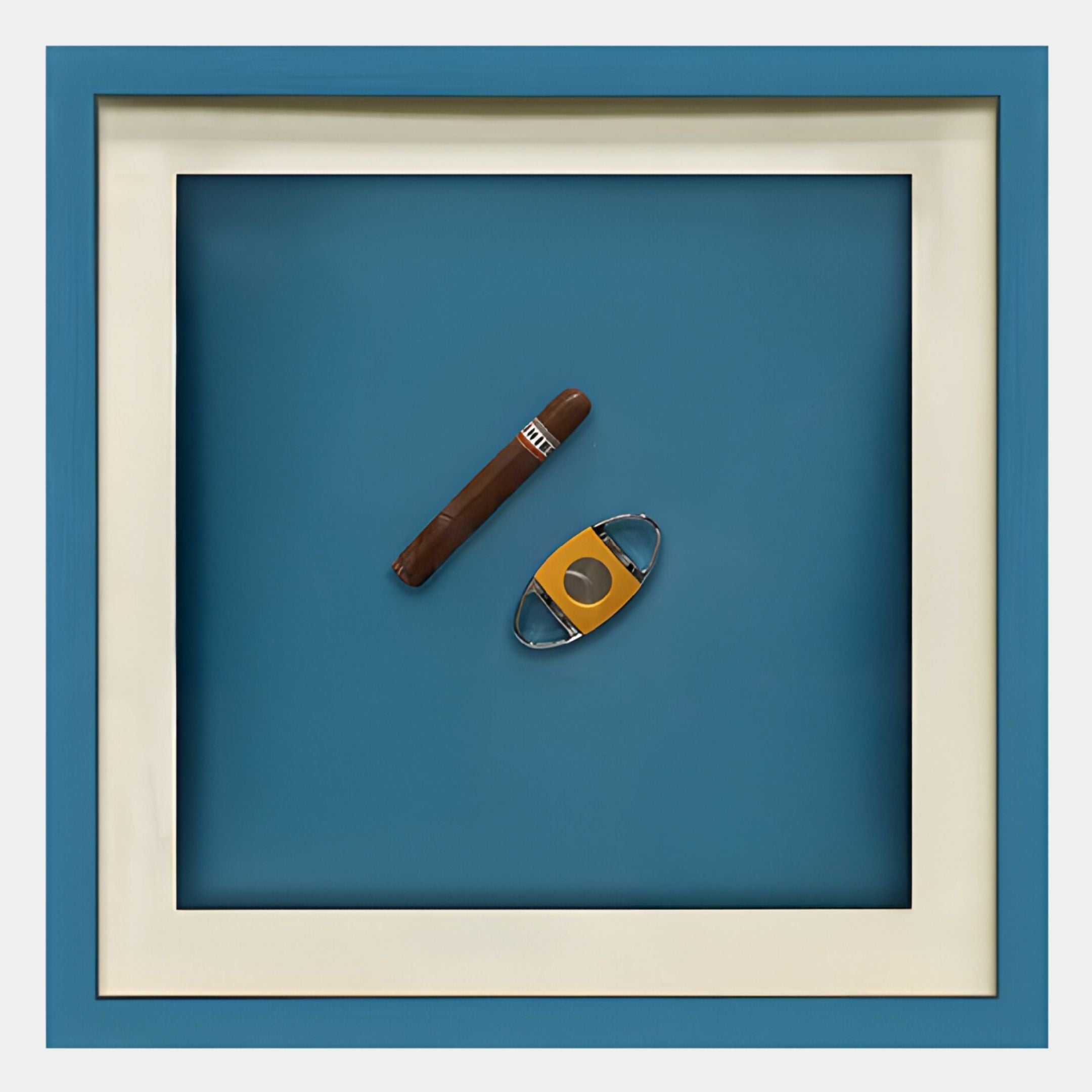 Giant Sculptures’ Cavallero Teal Cigar & Cutter Framed Wall Art features a striking cigar and yellow cutter on a blue backdrop—ideal as contemporary wall art or bold teal decor for modern interiors.