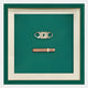 The Cavallero Green Cigar & Cutter Framed Wall Art by Giant Sculptures features a contemporary cigar and cutter design on a green background, bordered with white and green frames—a unique decorative touch for any space.