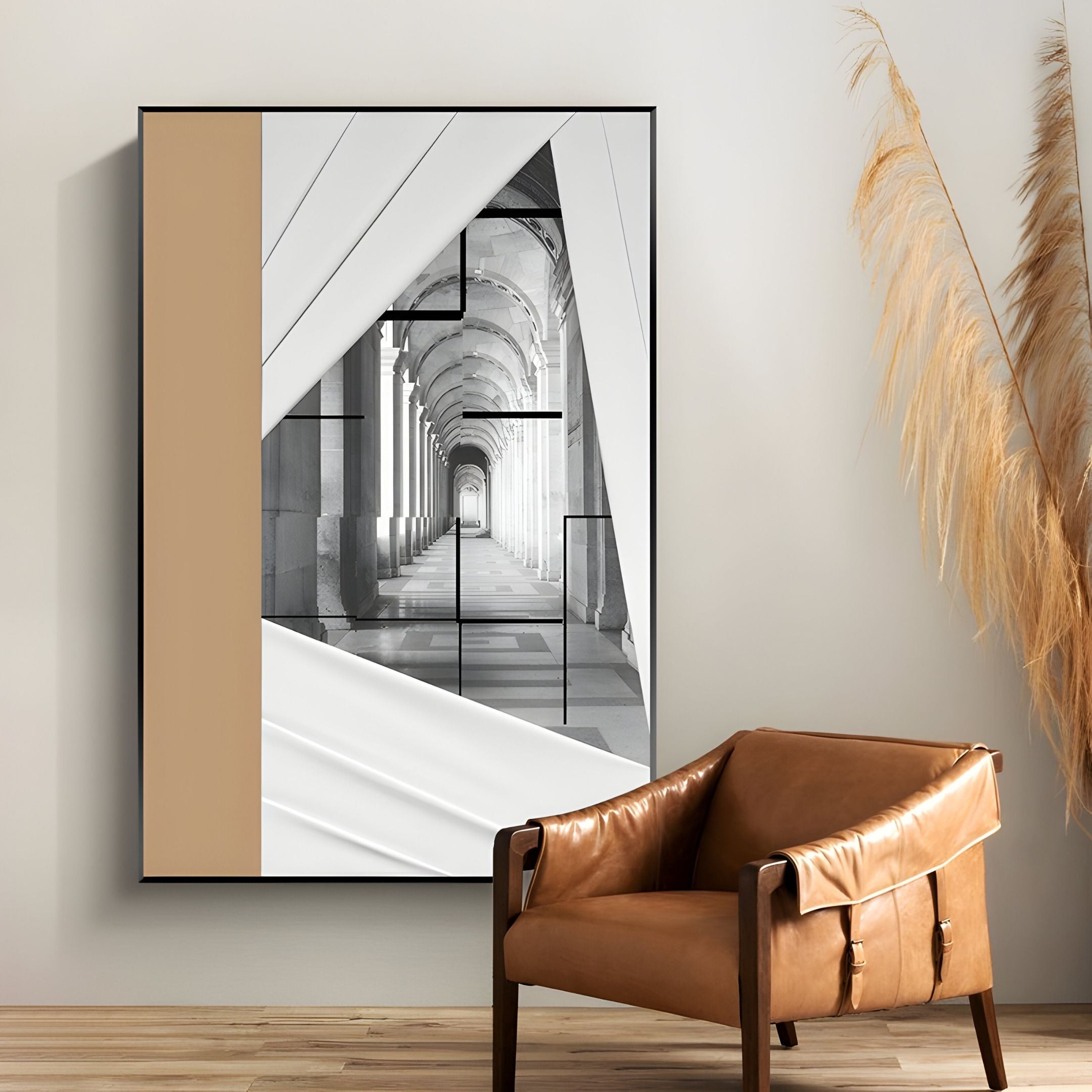 A modern interior features Giant Sculptures' Arclustre Sand & White Draped Corridor 3D Wall Art, framed above a brown leather armchair and a vase of tall pampas grass on a wooden floor.