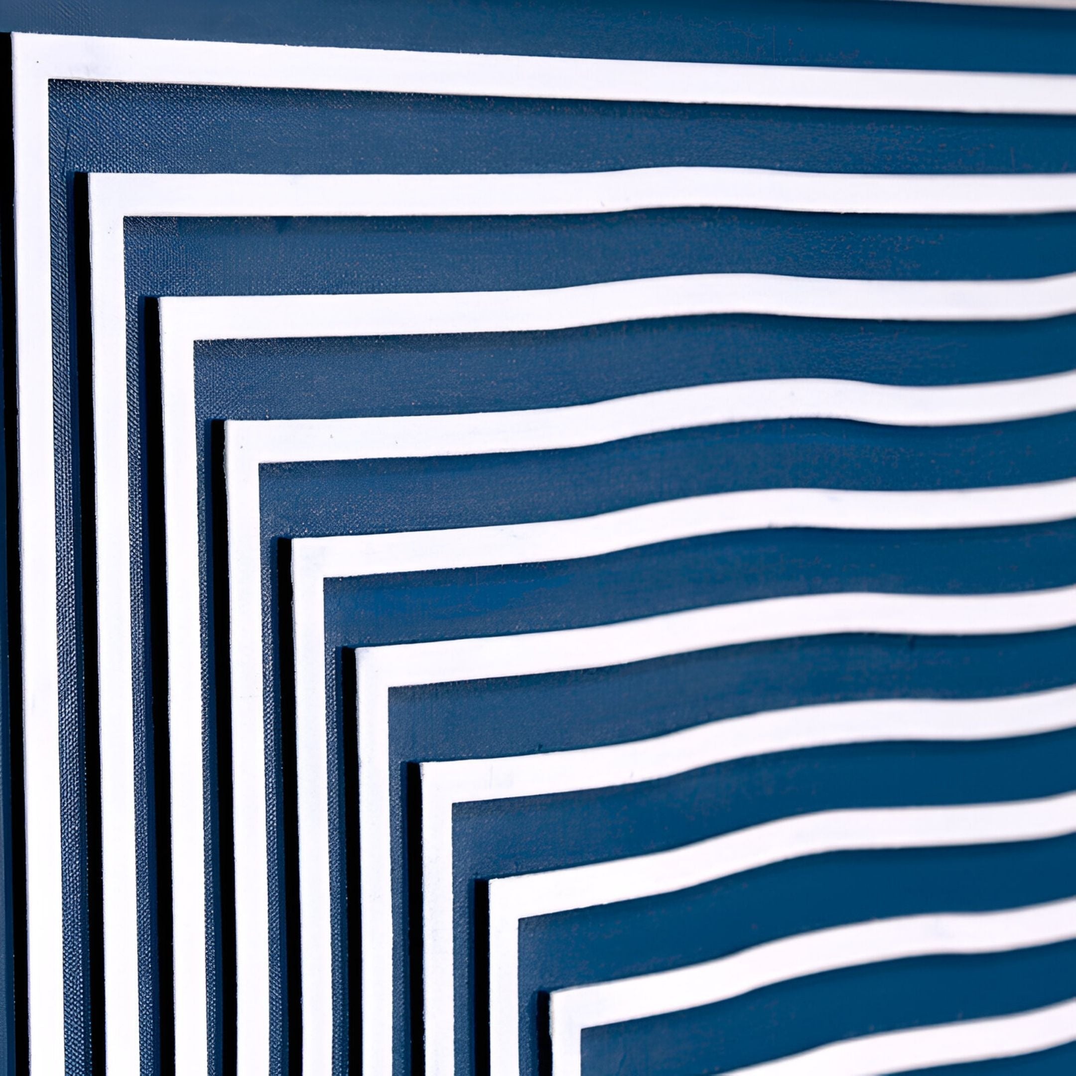 The Linscape Blue Linear Wood Relief 3D Wall Art by Giant Sculptures features wavy parallel lines in a stepped pattern on a dark blue background, creating depth and movement—ideal as modern wall art for contemporary interiors.