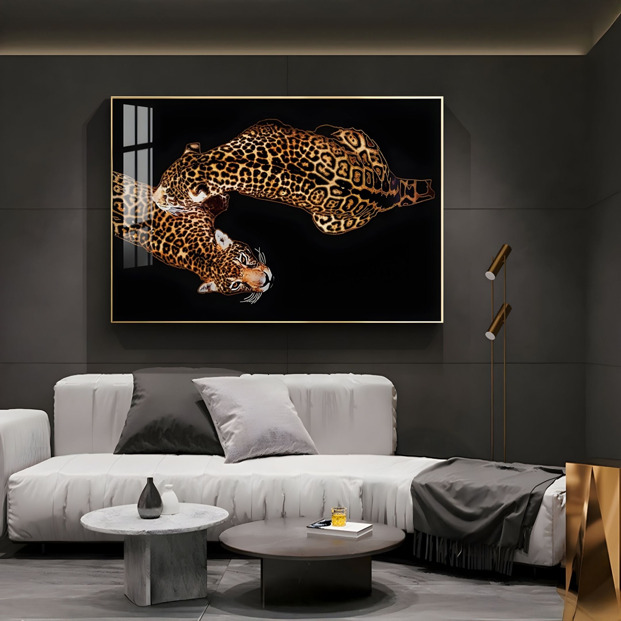 A modern living room features a white sofa with gray pillows, a marble coffee table, and Giant Sculptures' Auravalor Twin Leopards Crystal Porcelain 3D Wall Art above the sofa, adding luxurious decor to the dark wall.