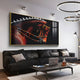 A modern living room with a black leather sofa, neutral pillows, a laptop on the coffee table, and the Auravalor Red Stallion Crystal Porcelain 3D Wall Art by Giant Sculptures above. Contemporary ceiling lights complete the scene.