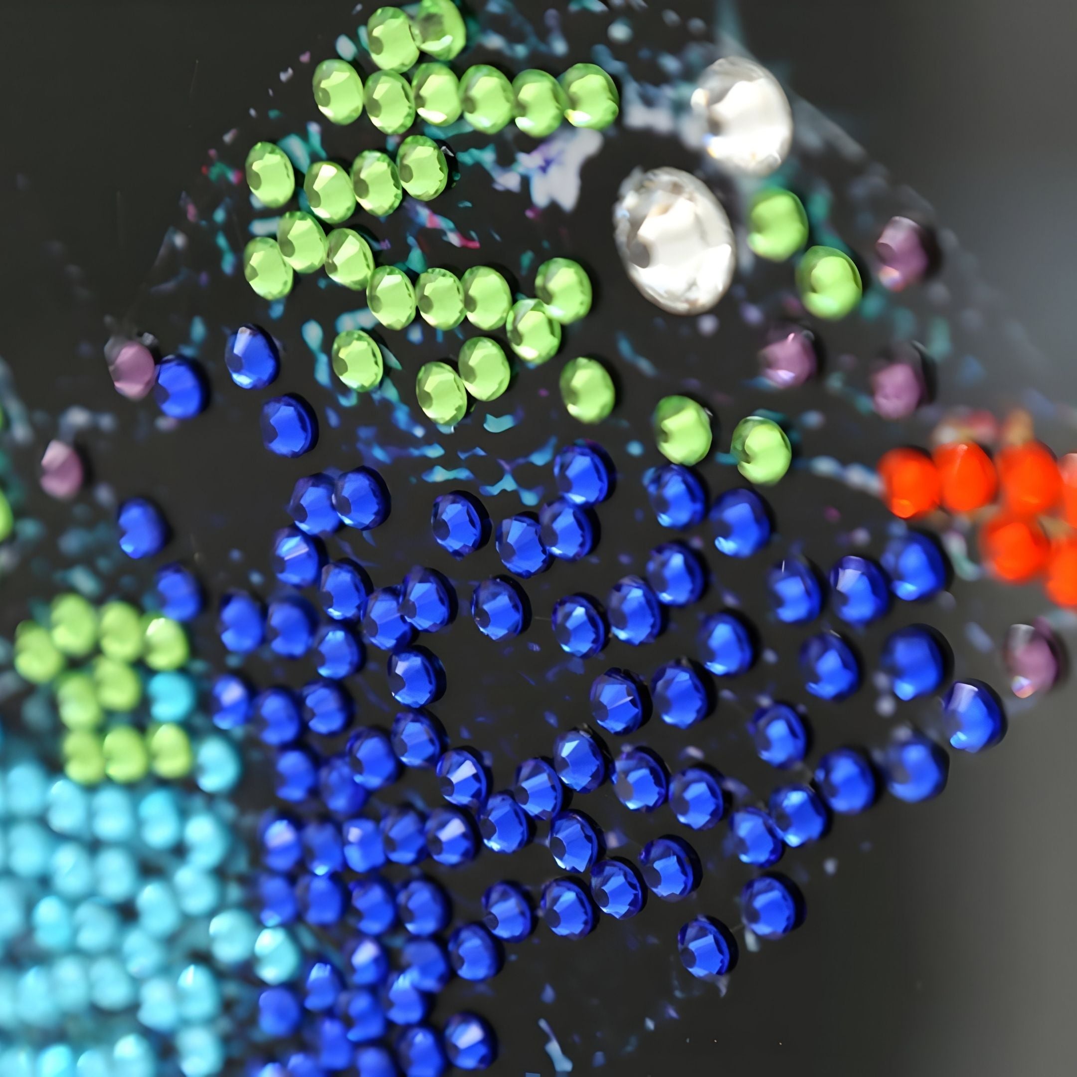 Close-up of the Auravalor Blue Butterfly Crystal Porcelain 3D Wall Art by Giant Sculptures, featuring a black surface adorned with shiny blue, green, red, purple, silver, and turquoise round beads in a vibrant pattern.