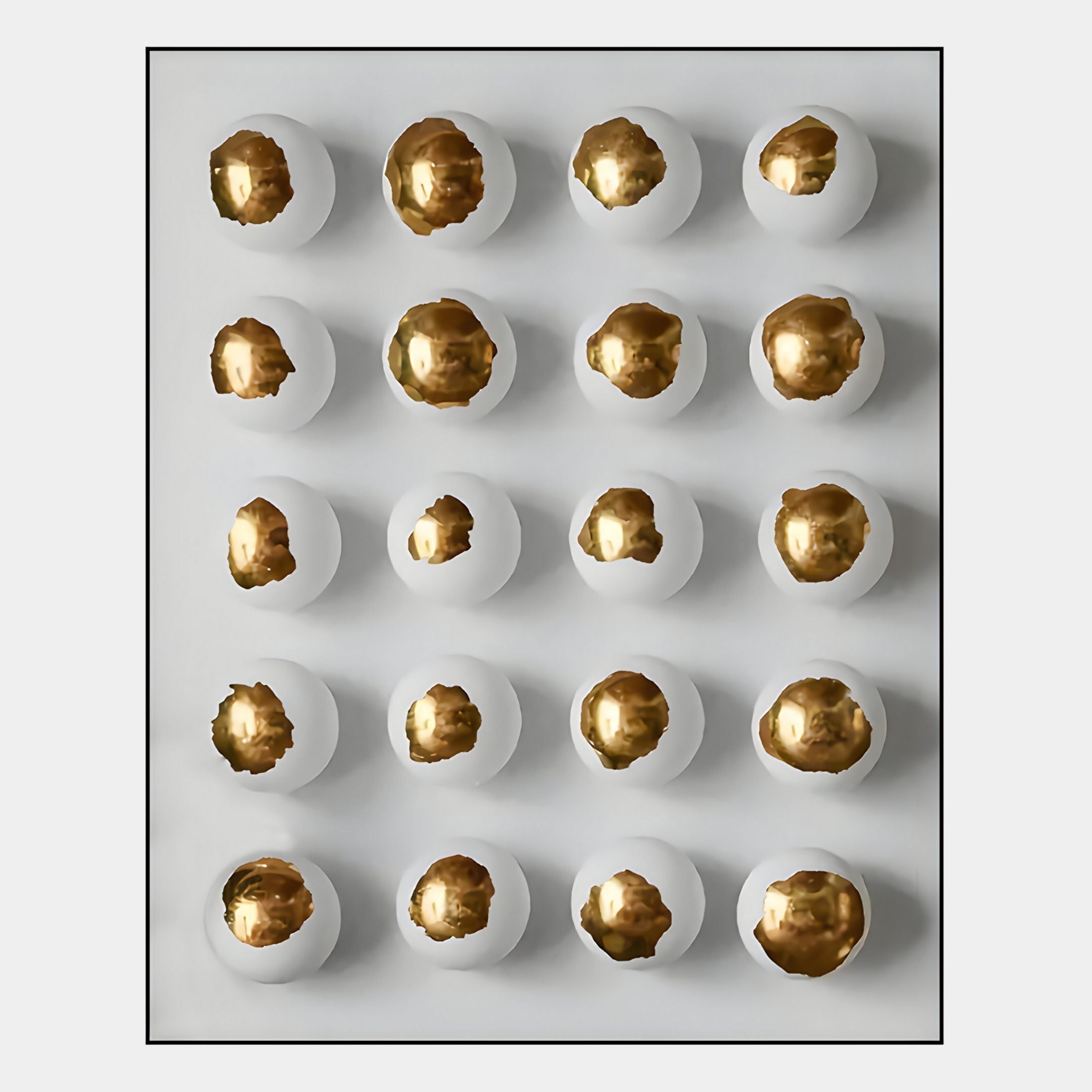 The Orbivelle Gold Patch Sphere & White Panel 3D Wall Art by Giant Sculptures features twenty white eggshell halves with gleaming gold interiors, arranged in five rows and four columns for a bold, contemporary wall display.