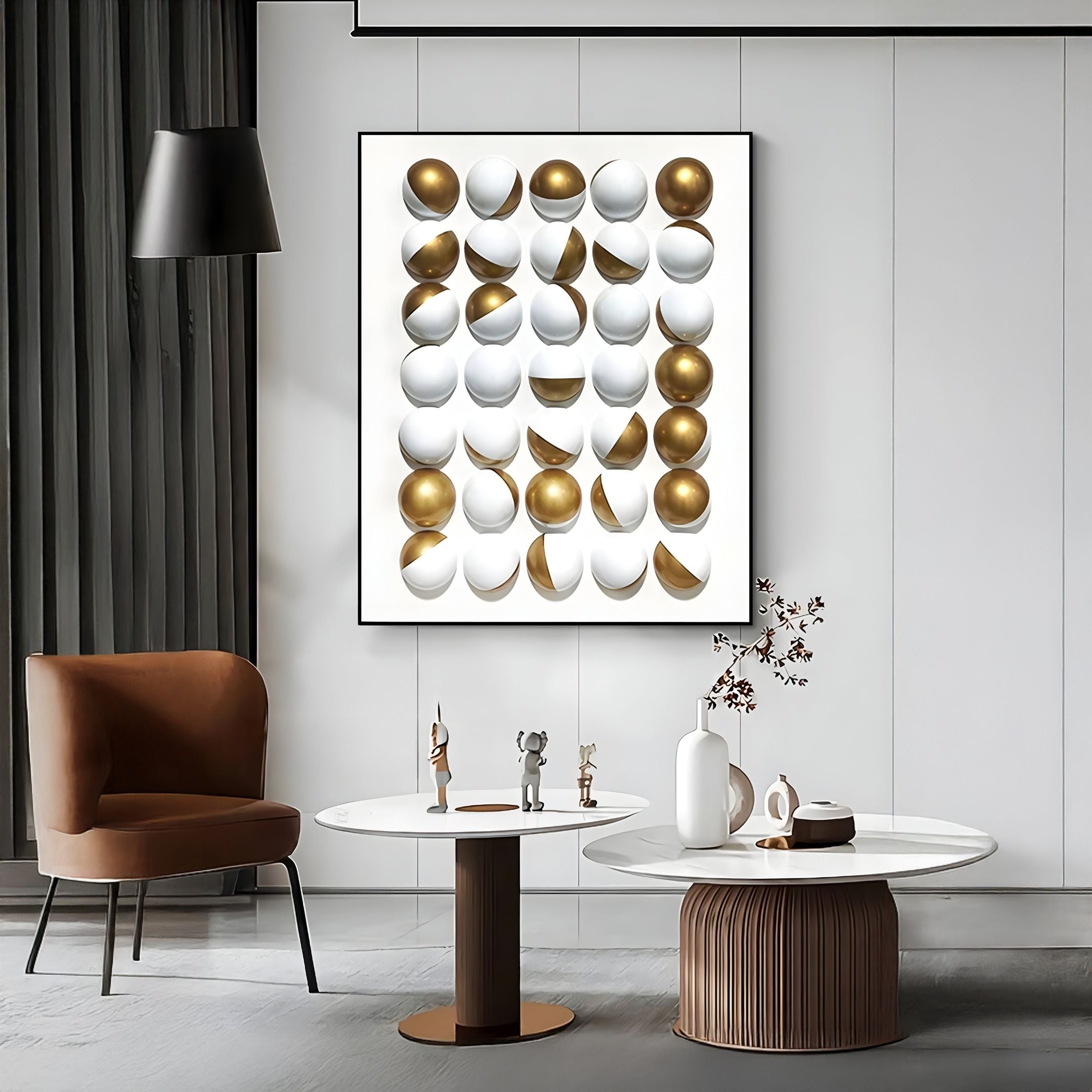 A modern living room in neutral tones showcases a brown chair, two round white tables with décor, a black hanging lamp, sheer curtains to the left, and Giant Sculptures' Orbivelle Gold Split Sphere & White Panel 3D Wall Art.