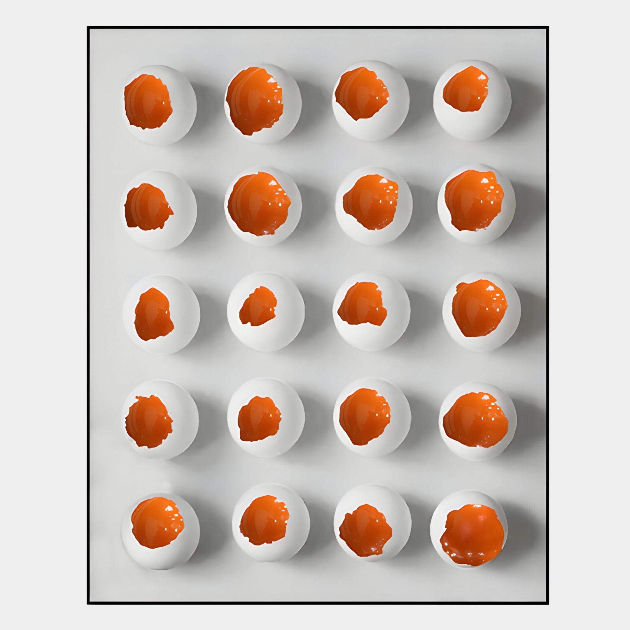 The Orbivelle Amber Patch Sphere & White Panel 3D Wall Art by Giant Sculptures features sixteen white eggshells with cracked tops and vivid orange yolks, creating bold, modern decor for any contemporary space.