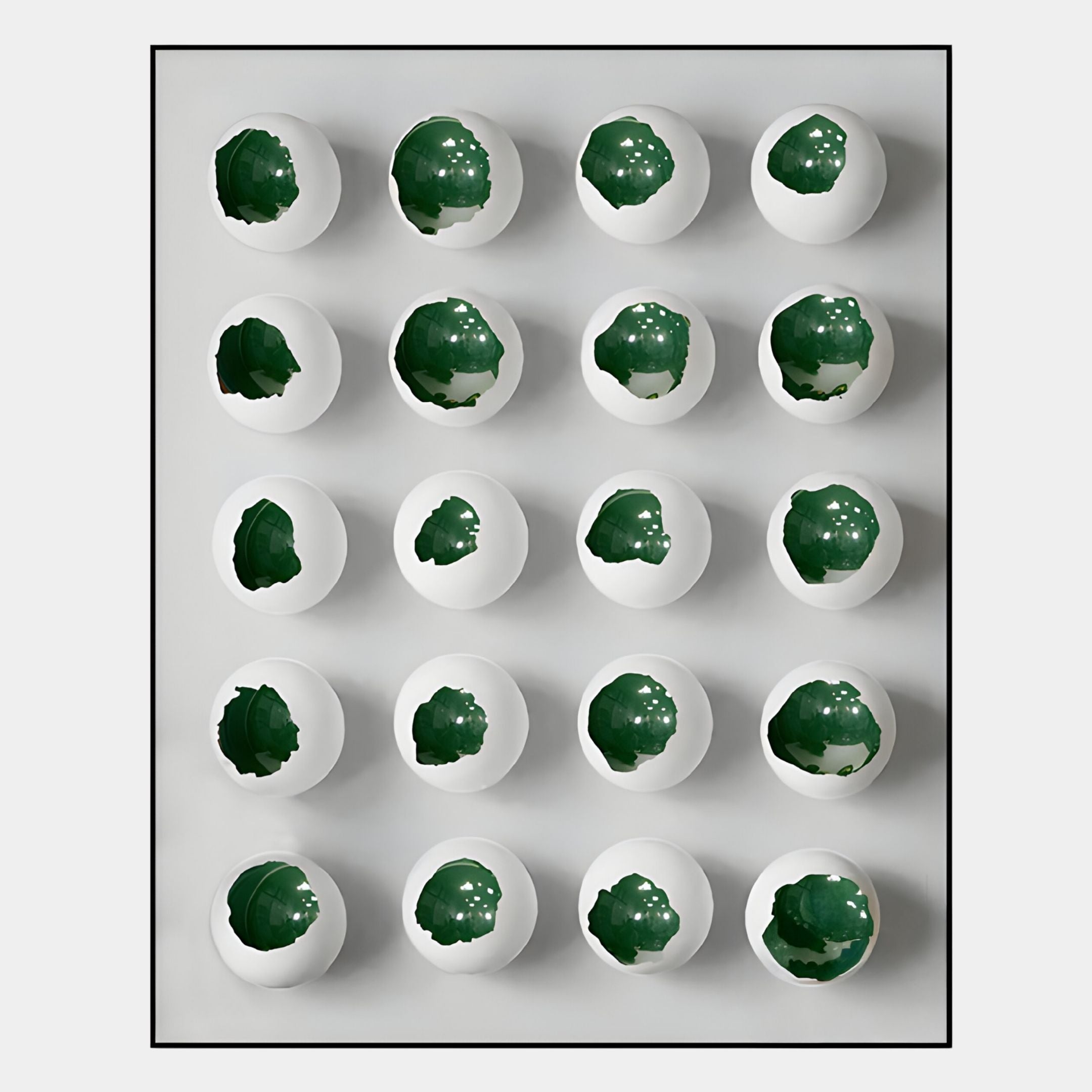 Orbivelle Emerald Patch Sphere & White Panel 3D Wall Art by Giant Sculptures features 20 white eggshell halves with green leafy centers against a light grey backdrop, creating bold contrast and a fresh accent for modern interiors.