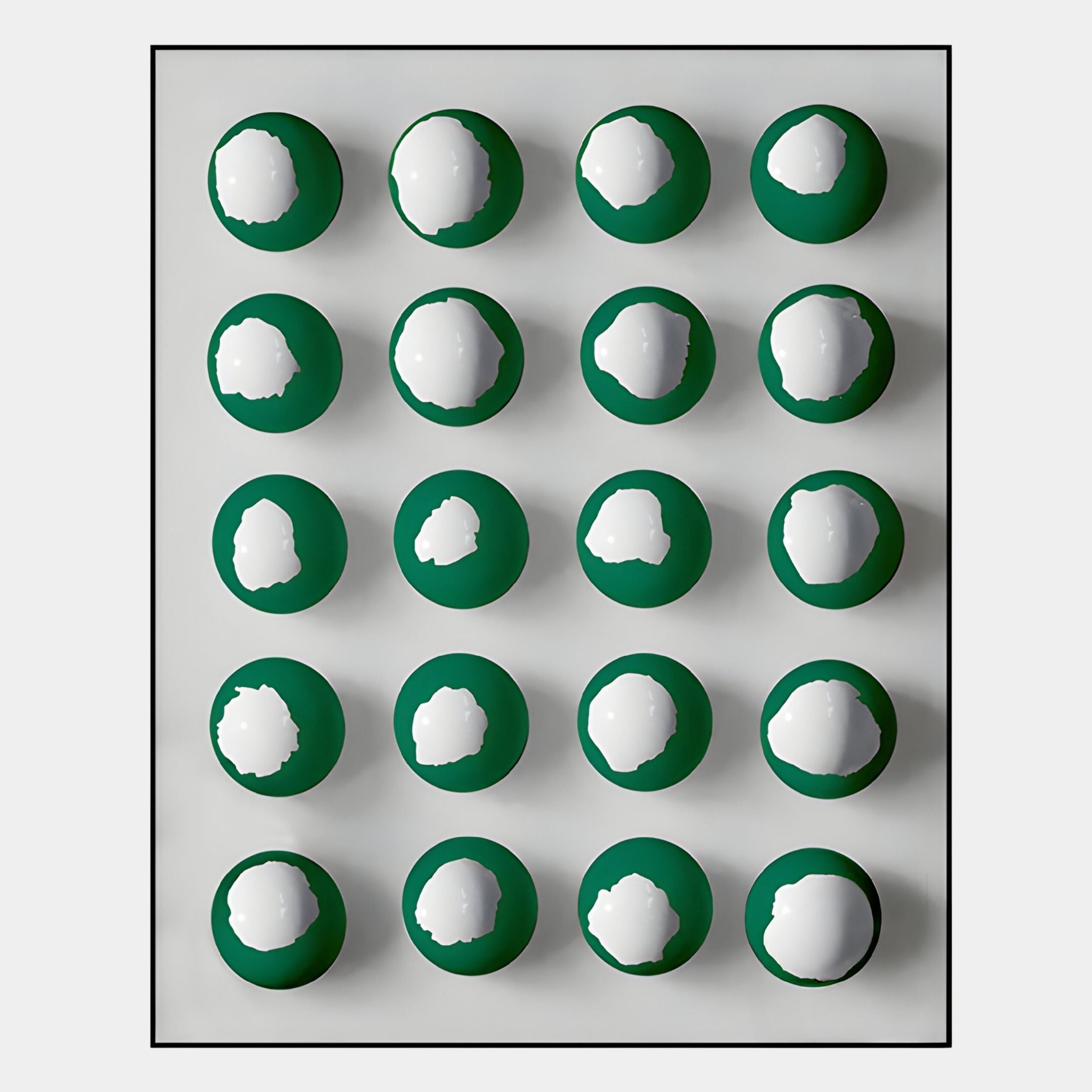 The Orbivelle Emerald & White Patch Sphere Panel 3D Wall Art by Giant Sculptures features twenty emerald and white spheres in a four-by-five grid with irregular spots, set on a light background and framed in black for bold decor.