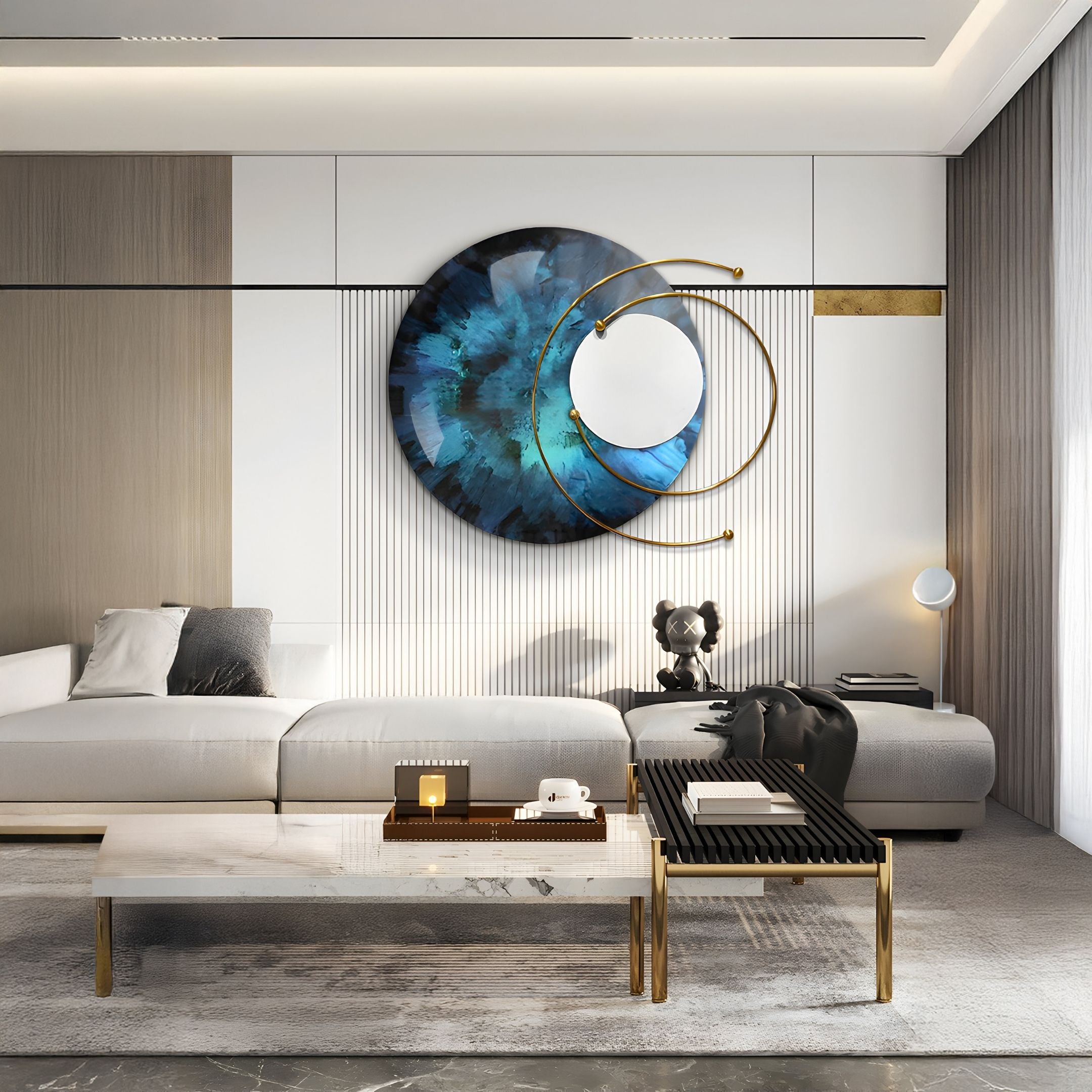 A modern living room with a white sectional sofa, minimalist coffee table, Giant Sculptures' Aurelios Deep Teal Crystal Porcelain & Gold Orbit 3D Wall Art above the seating, a sculptural black dog figure, and neutral-toned walls and floor.