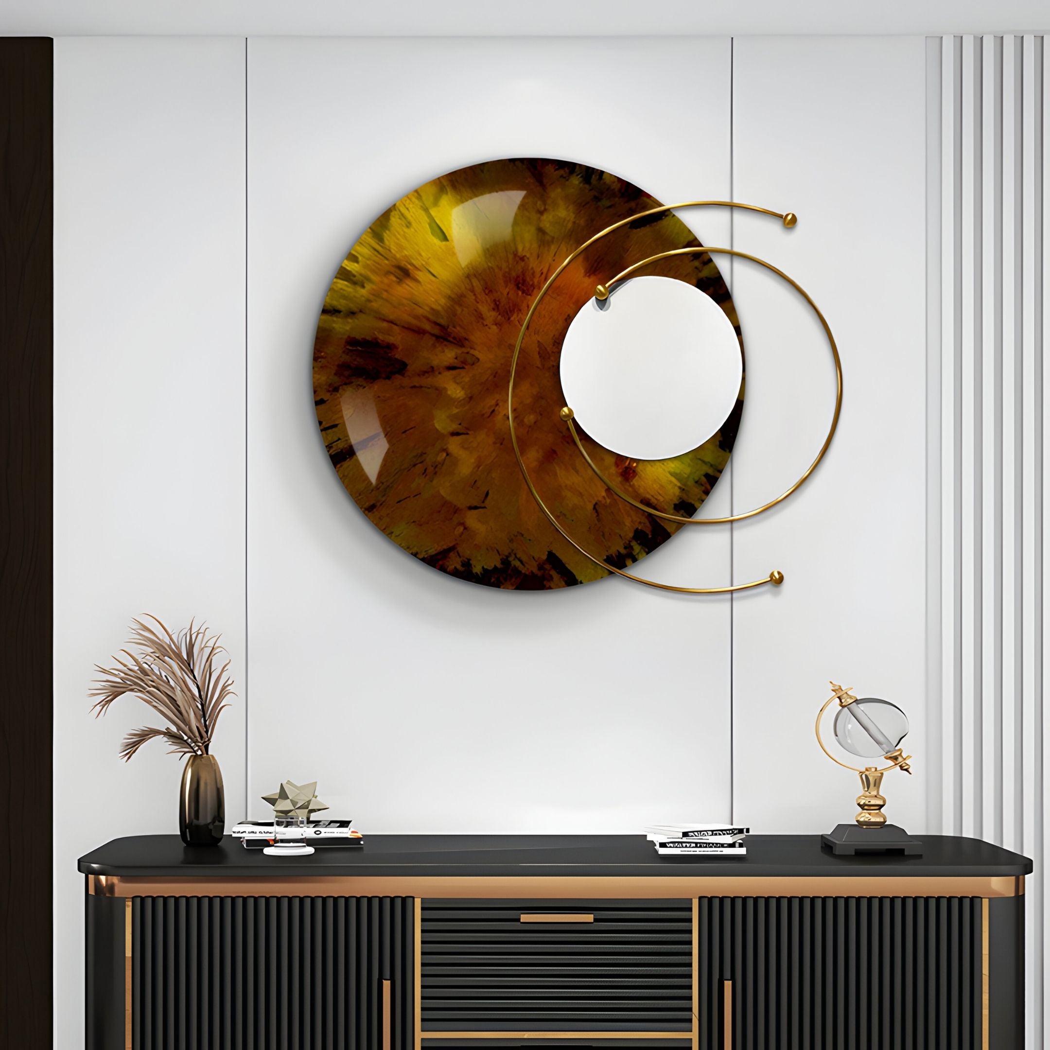 A modern living room features the Aurelios Amber Crystal Porcelain & Gold Orbit 3D Wall Art by Giant Sculptures in earthy tones, mounted above a black and gold console table adorned with books, a globe, and a vase of dried plants.
