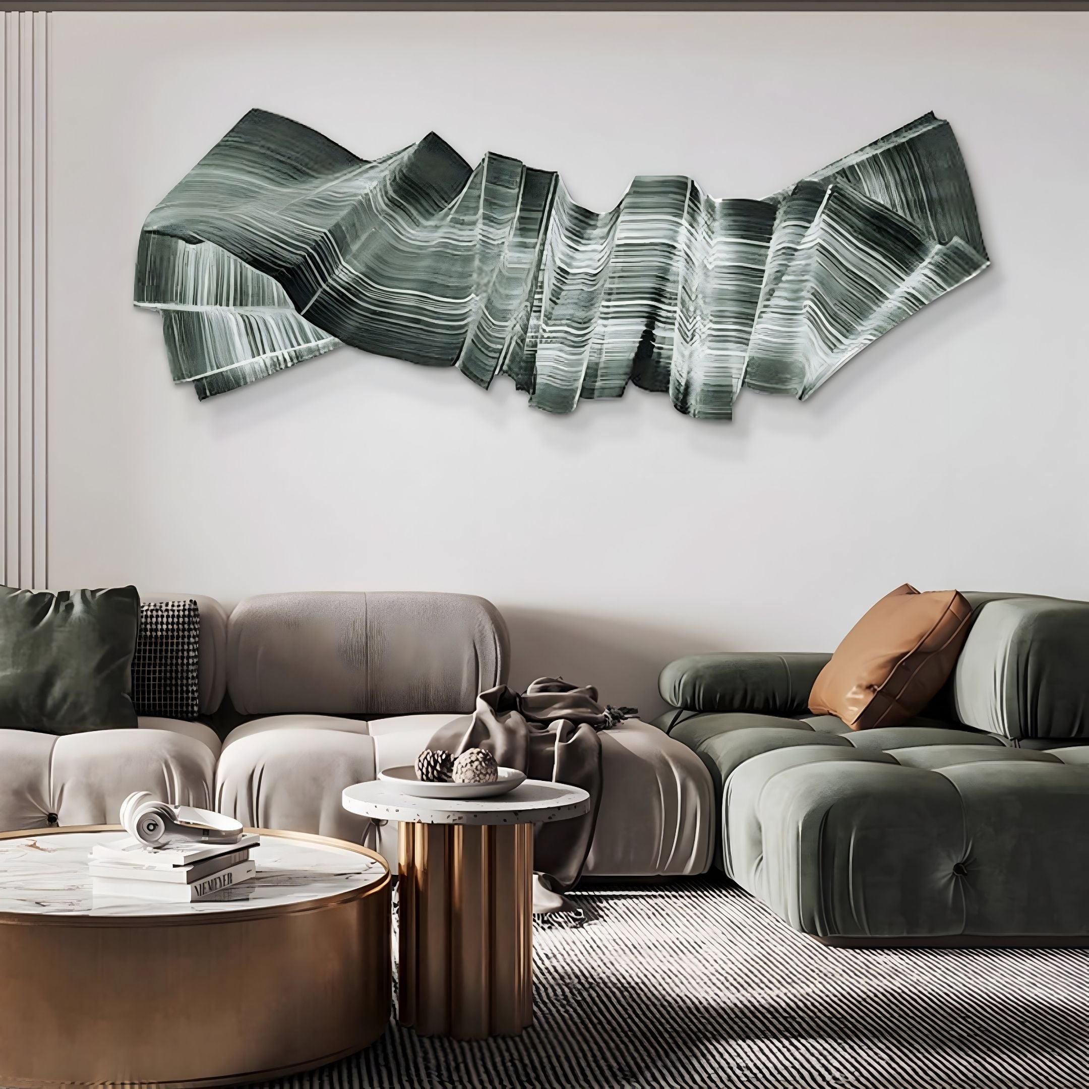 A modern living room with green and gray sofas, a round coffee table, and the Vellun Wave Sage Flow Sculptural 3D Wall Art by Giant Sculptures. The decor is minimal and contemporary.