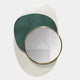 The Solistra Emerald III Layered Round Mirror 3D Wall Art by Giant Sculptures, with a gold frame, is displayed atop green and white abstract ovals, reflecting part of a white cabinet and wall.