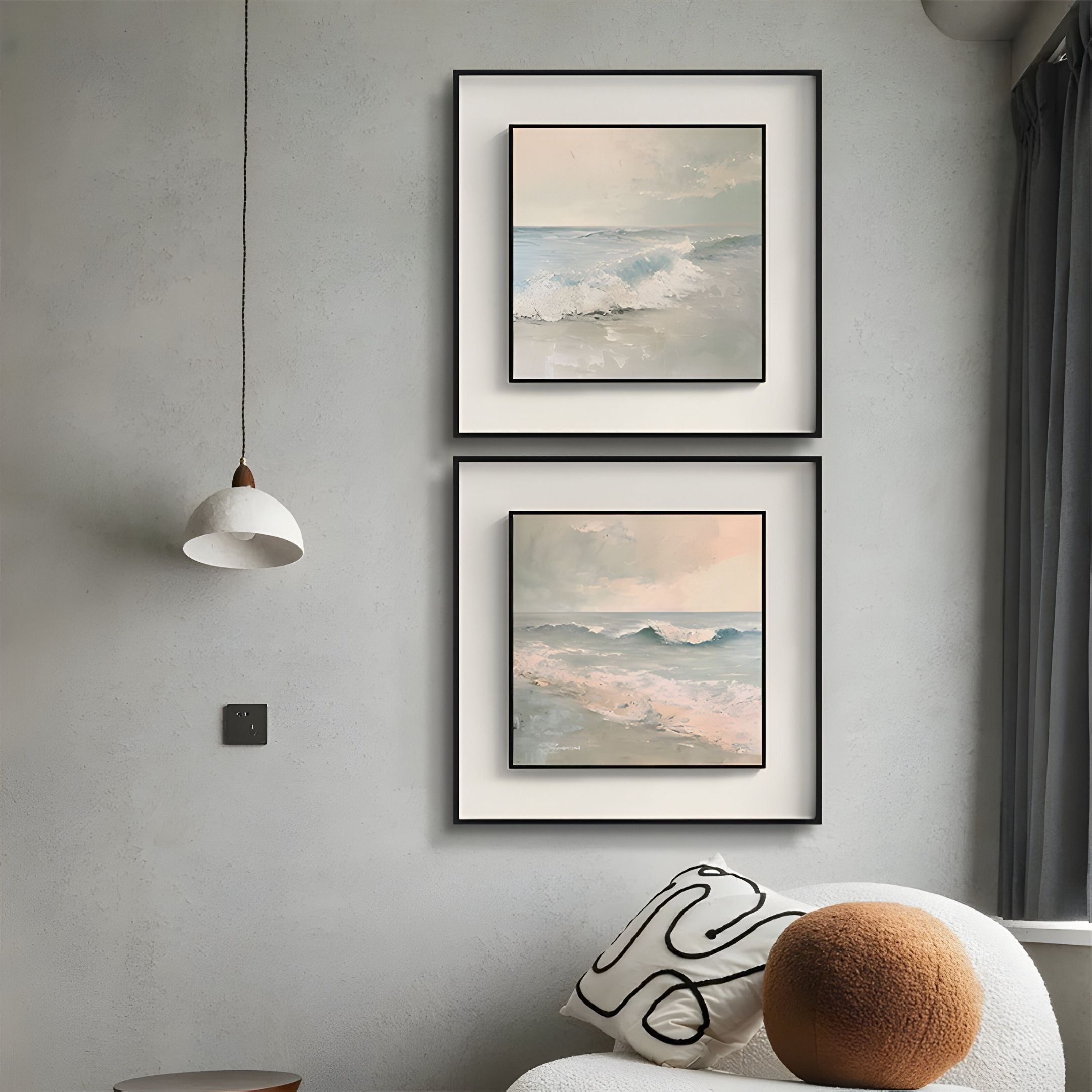 A modern living space with Giant Sculptures’ Tidalume II Soft Dawn Shoreline Double Framed Wall Art on a light gray wall, a white pendant lamp, round white chair with a patterned pillow, and a window with dark curtains.