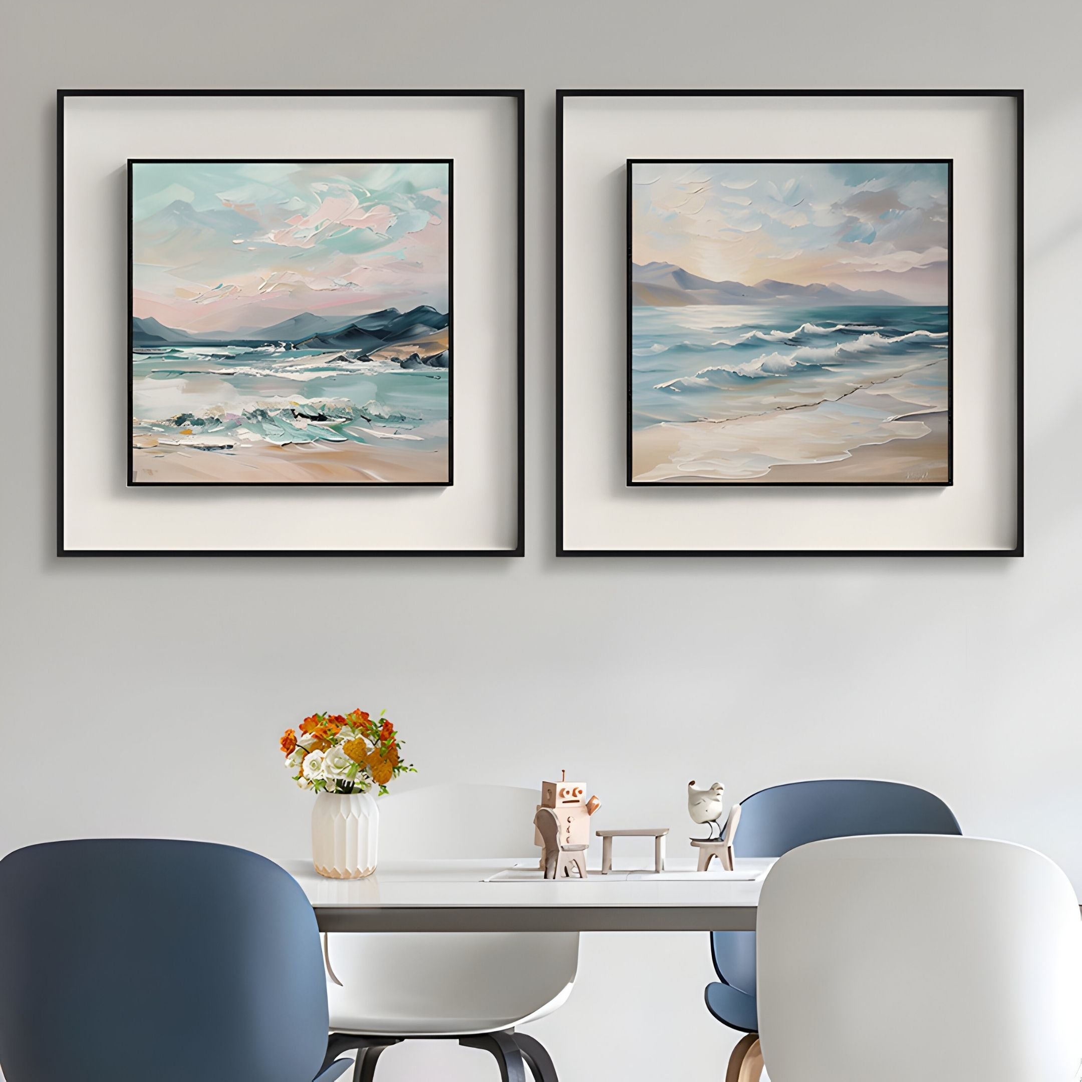 A modern dining area with a white table, blue and white chairs, a vase of flowers, and Giant Sculptures’ Marilline I Calm Coastal View Double Framed Wall Art on a light gray wall.