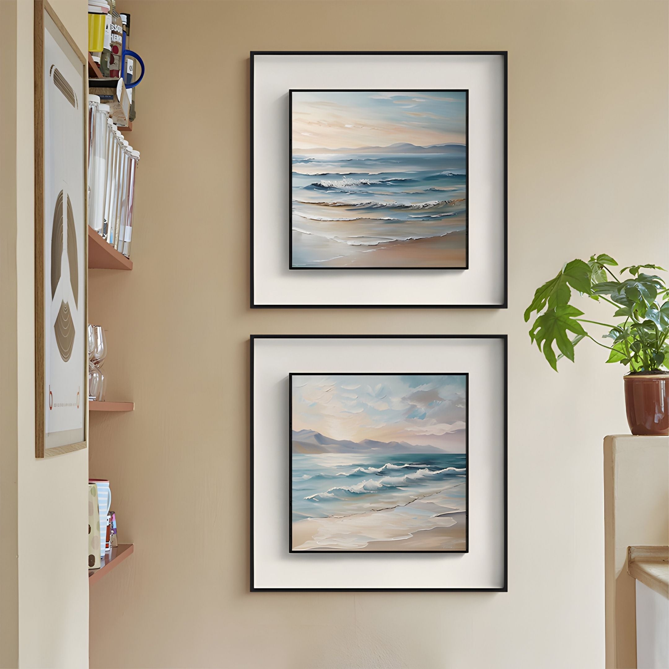 The Marilline II Calm Coastal View Double Framed Wall Art by Giant Sculptures hangs above a shelf with a potted plant on a beige wall. To the left, shelves display books and an abstract shapes poster, creating a calm and tidy atmosphere.