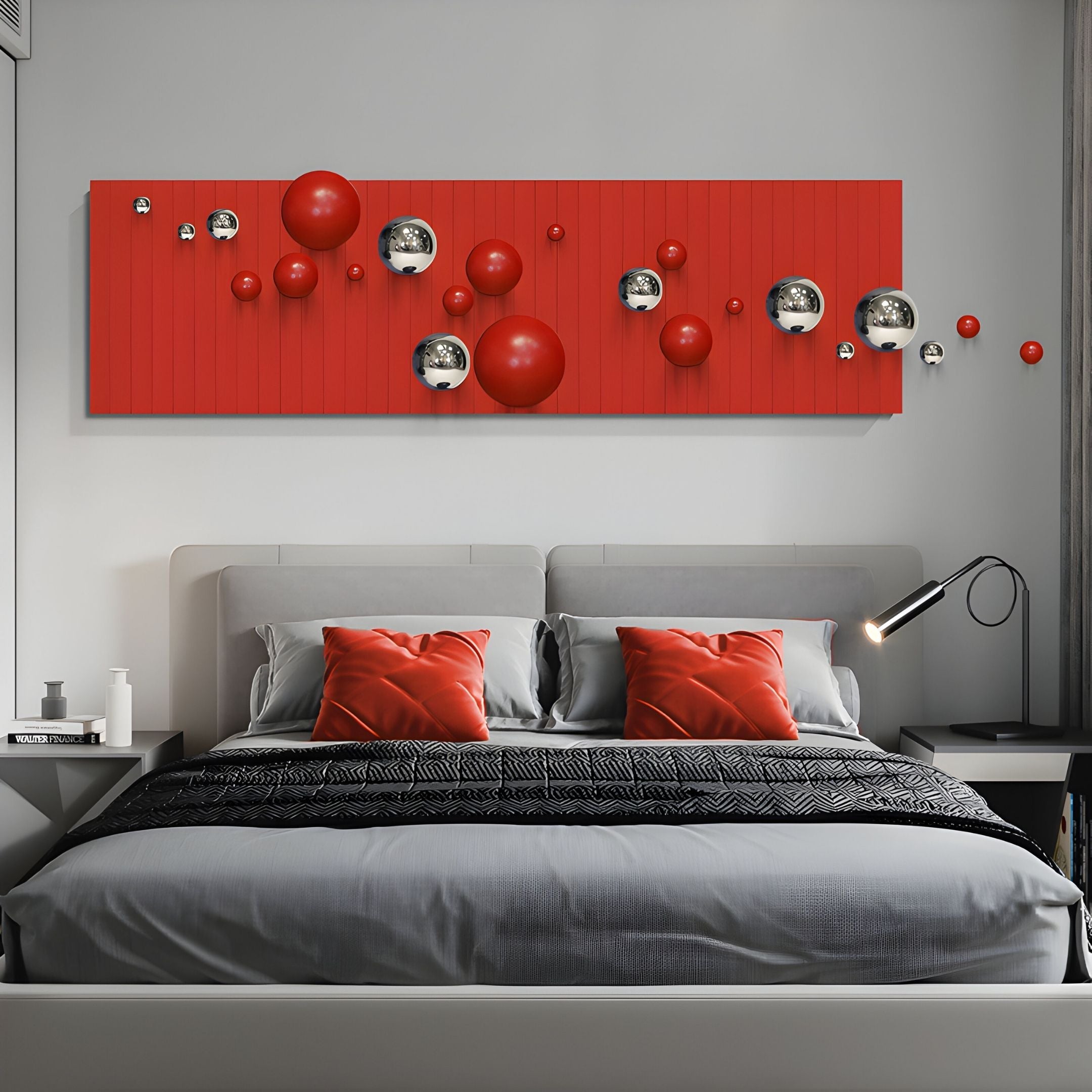 A modern bedroom features a gray bed, red and gray pillows, a black lamp, and above the bed, the striking Giant Sculptures Orbivance Red & Silver Sphere Panel 3D Wall Art with stainless steel spheres and red accents as a bold focal point.