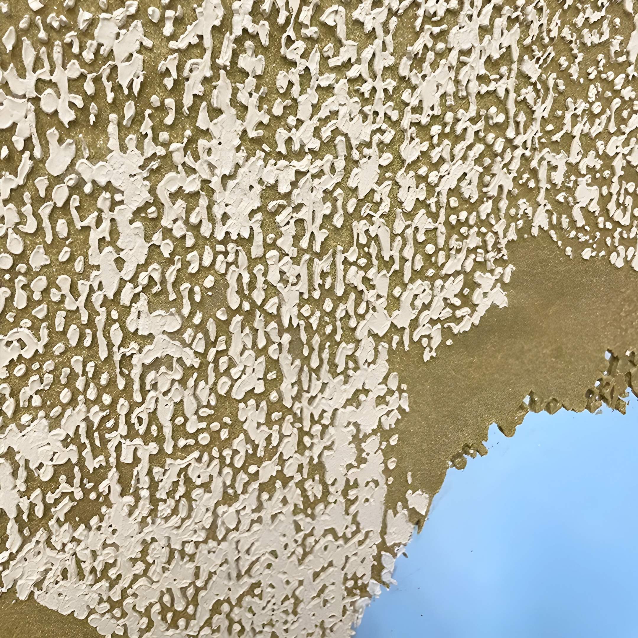 The Auritone Gold Textured Steel Mirrored 3D Wall Art by Giant Sculptures features chipped white paint revealing gold beneath, with blue accents in the corner for added depth and modern intrigue.