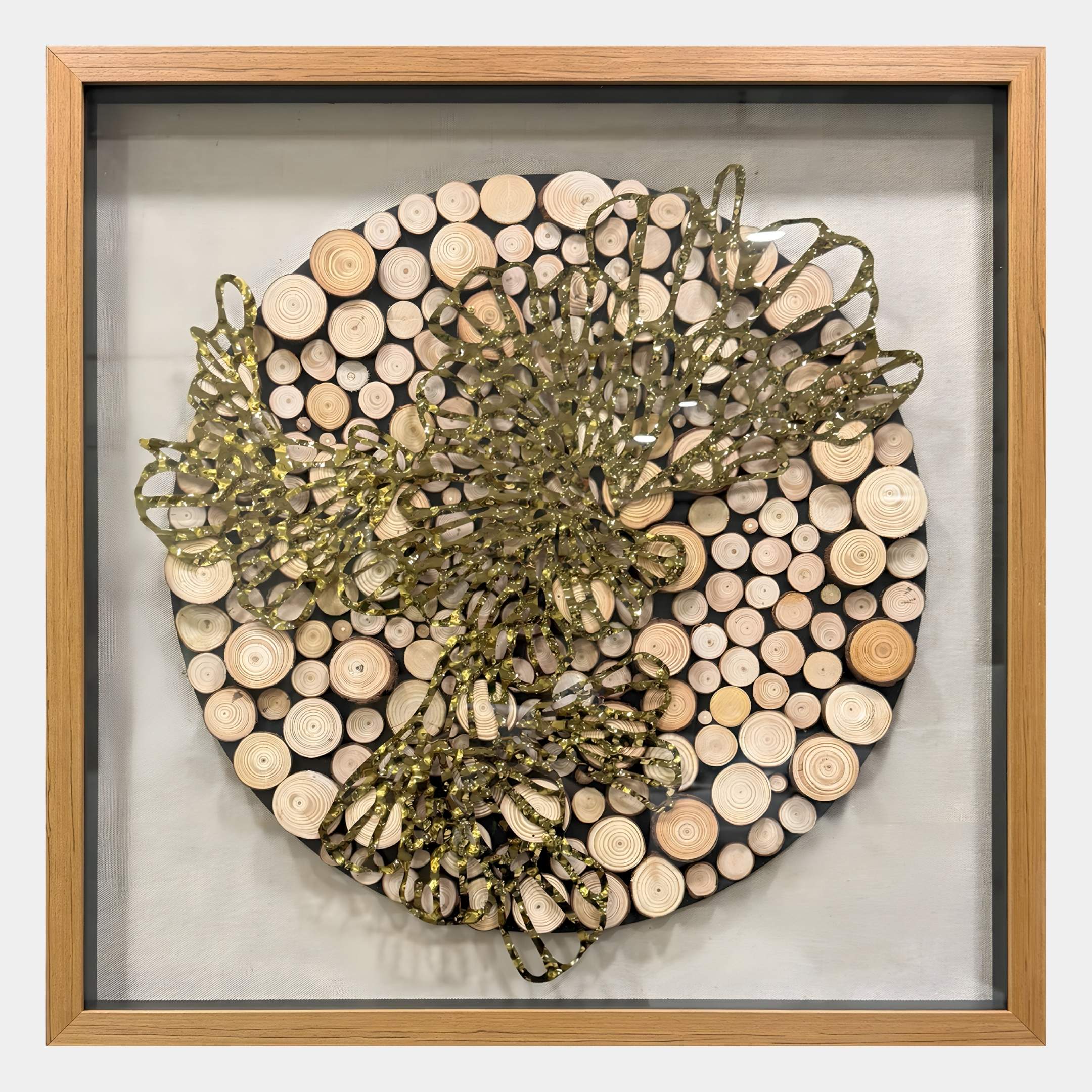 The Giant Sculptures Arborique Radiant Bloom Gold Steel & Wood 3D Wall Art features an abstract gold and green design on circular wooden discs, framed in light wood with a light gray background.