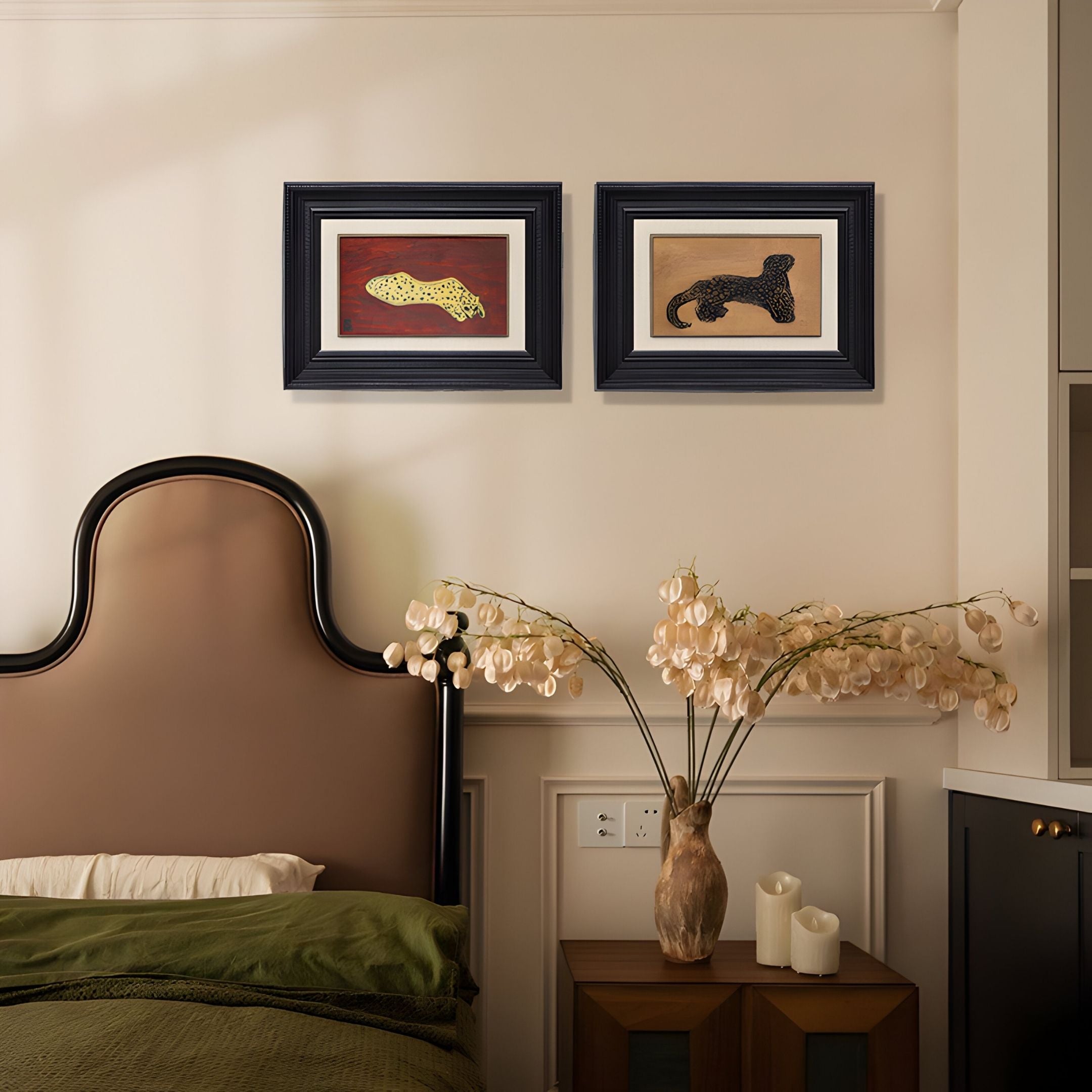 A cozy bedroom features a bed with a brown headboard, green bedding, a nightstand with a vase of dried flowers, and the Kansora Leopard Emblem 2-Set Framed Wall Art by Giant Sculptures displayed above.