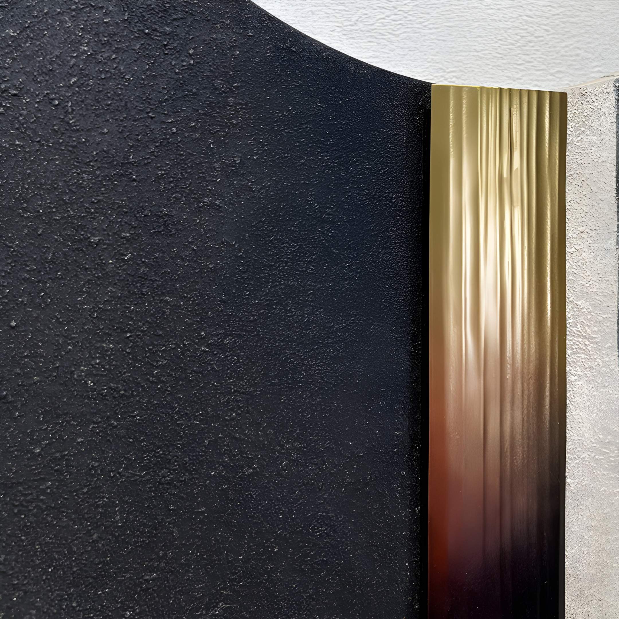 The Vortaryn Charcoal & Concrete Circle Sculptural 3D Wall Art by Giant Sculptures features a textured black surface, smooth metallic gold vertical strip, and rough light gray section on a white curved background.