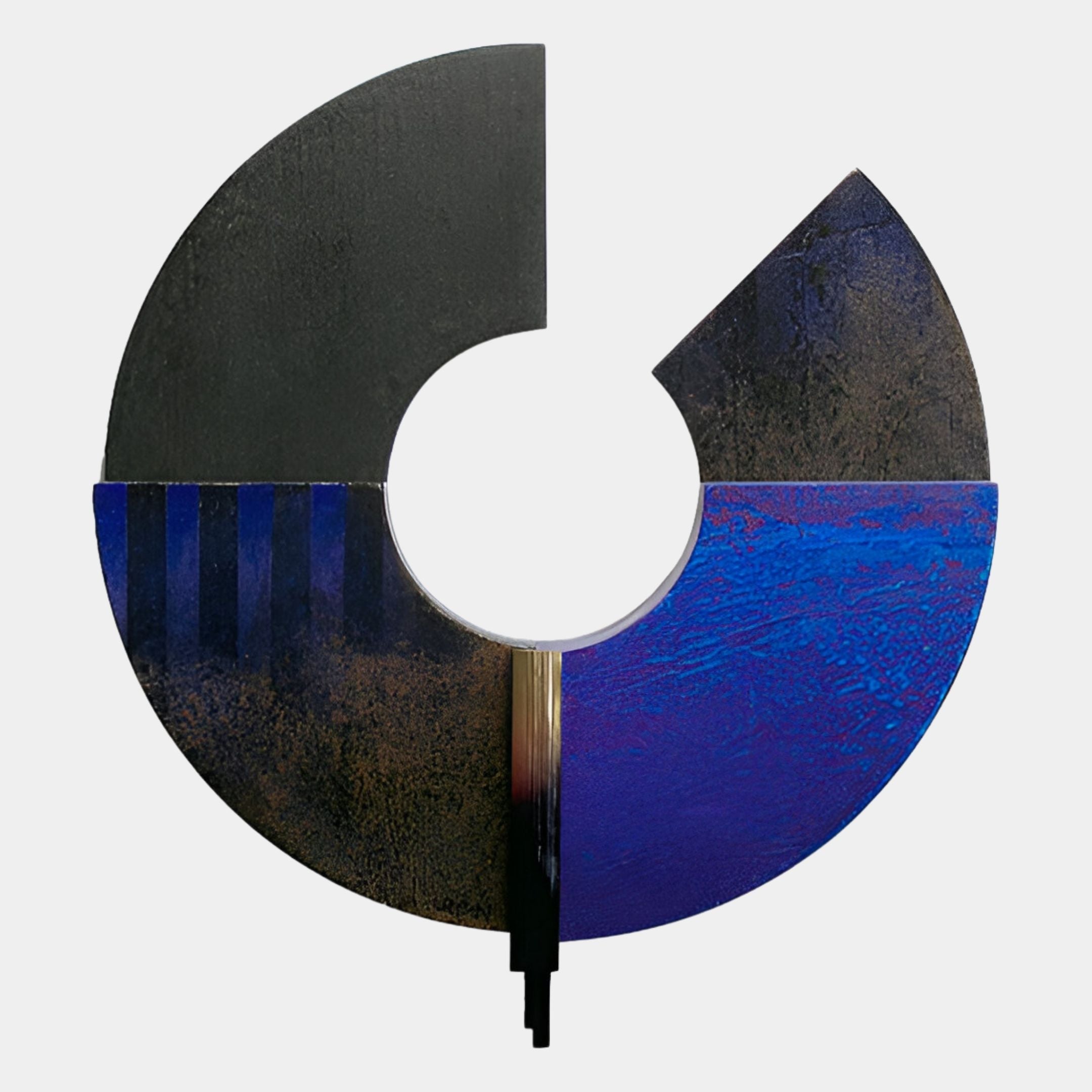 The Vortaryn Midnight Blue & Grey Circle Sculptural 3D Wall Art by Giant Sculptures features a circular, abstract design split into three segments: black left, dark blue right, and lower blue-gold with vertical blue stripes and a central cutout.
