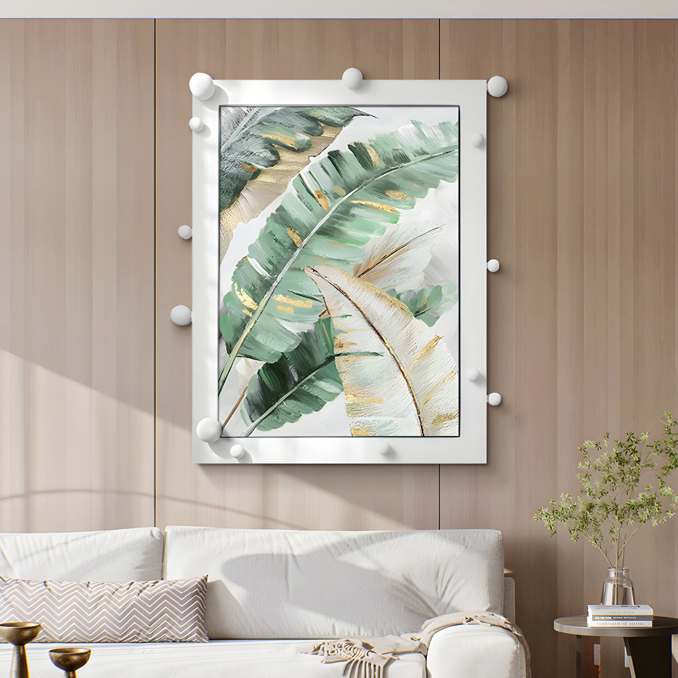 A modern living room features a white couch, decorative pillows, and a glass vase with greenery. The wooden-paneled wall displays Giant Sculptures’ Verdantia I Green & Gold Leaf Textured 3D Wall Art.