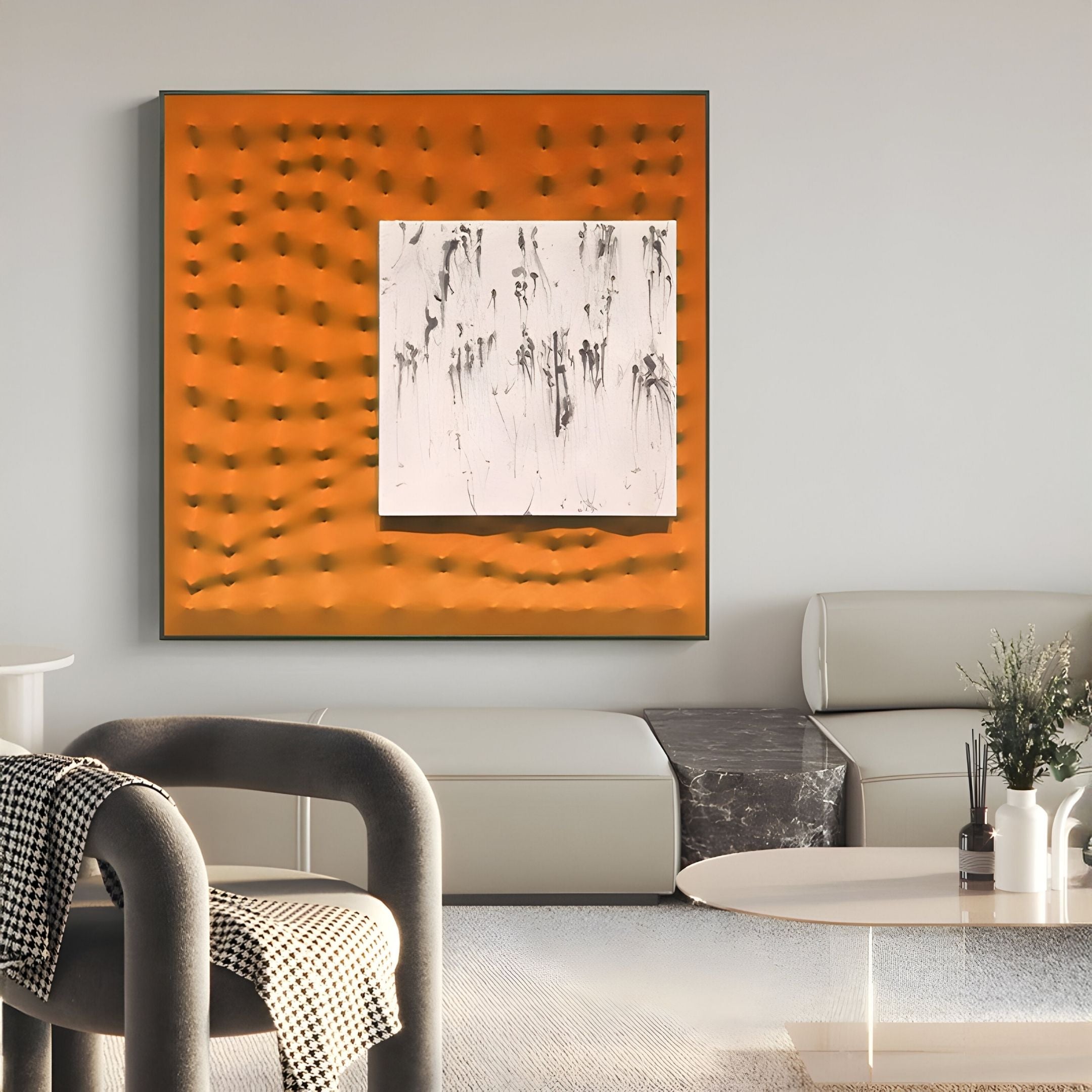 A modern living room with minimalist beige furniture, a marble coffee table, and Giant Sculptures’ Loftera Orange Sculpted Fabric & Abstract Canvas 3D Wall Art. A small vase with greenery sits on the table.