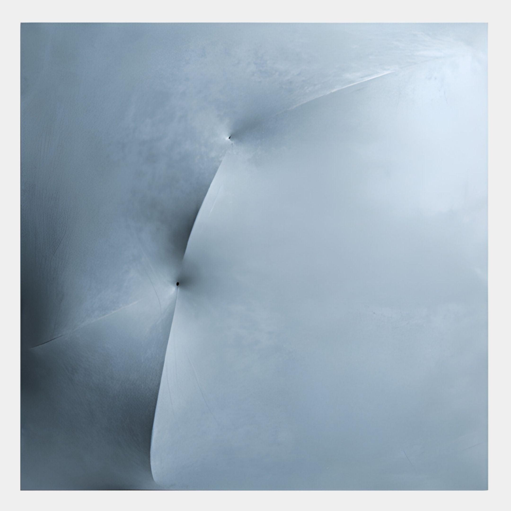 Abstract image with smooth, curved surfaces in pale blue and gray evokes "Veylora Ice Blue Folded Texture Fabric 3D Wall Art" by Giant Sculptures. Two dark points suggest punctures, adding a subtle 3D effect.