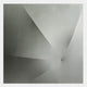 The Veylora Mist Silver Folded Texture Fabric 3D Wall Art by Giant Sculptures features abstract grayscale geometric folds radiating from a single point, embodying sculptural minimalism and depth on a smooth background.