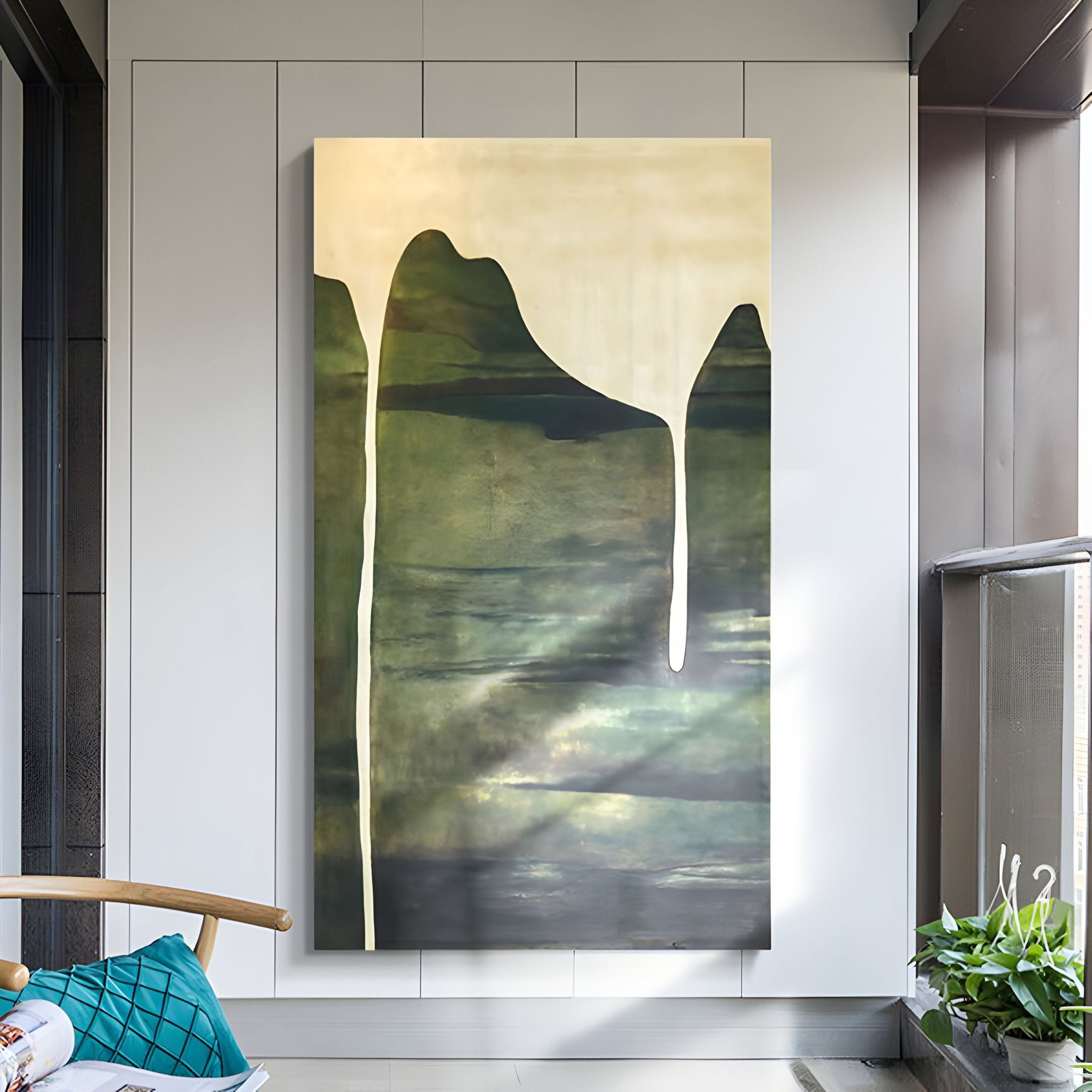 The Seralyon Green Drip Peak Vertical Canvas Wall Art by Giant Sculptures, with green and dark tones and flowing white lines, hangs on a modern white wall in a bright room featuring a window and a wooden chair with a teal cushion.