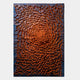 The Heliox Ember Radiance Sculptural 3D Wall Art by Giant Sculptures features raised orange rectangular blocks in a swirling vortex on a dark base—an ideal centerpiece for contemporary interiors.