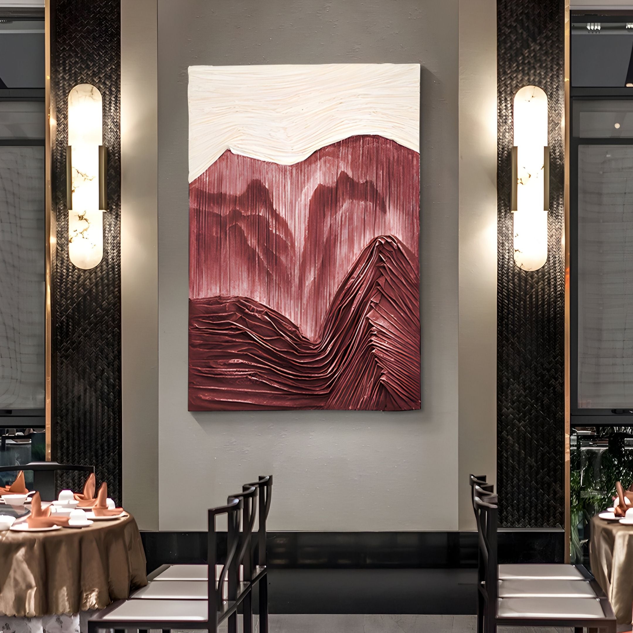 The Terralune Red Layered Ridge 3D Wall Art by Giant Sculptures, featuring burgundy and white layers, hangs on a restaurant wall between modern sconces above dining tables elegantly set with plates, glasses, folded napkins, and neatly arranged chairs.