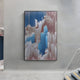 The Aerolune Rose & Blue Vertical Drift Rope 3D Wall Art by Giant Sculptures hangs on a light gray wall beside a staircase with metal rails, featuring vertical blue, pink, and white streaks in a digital glitch-inspired pattern.