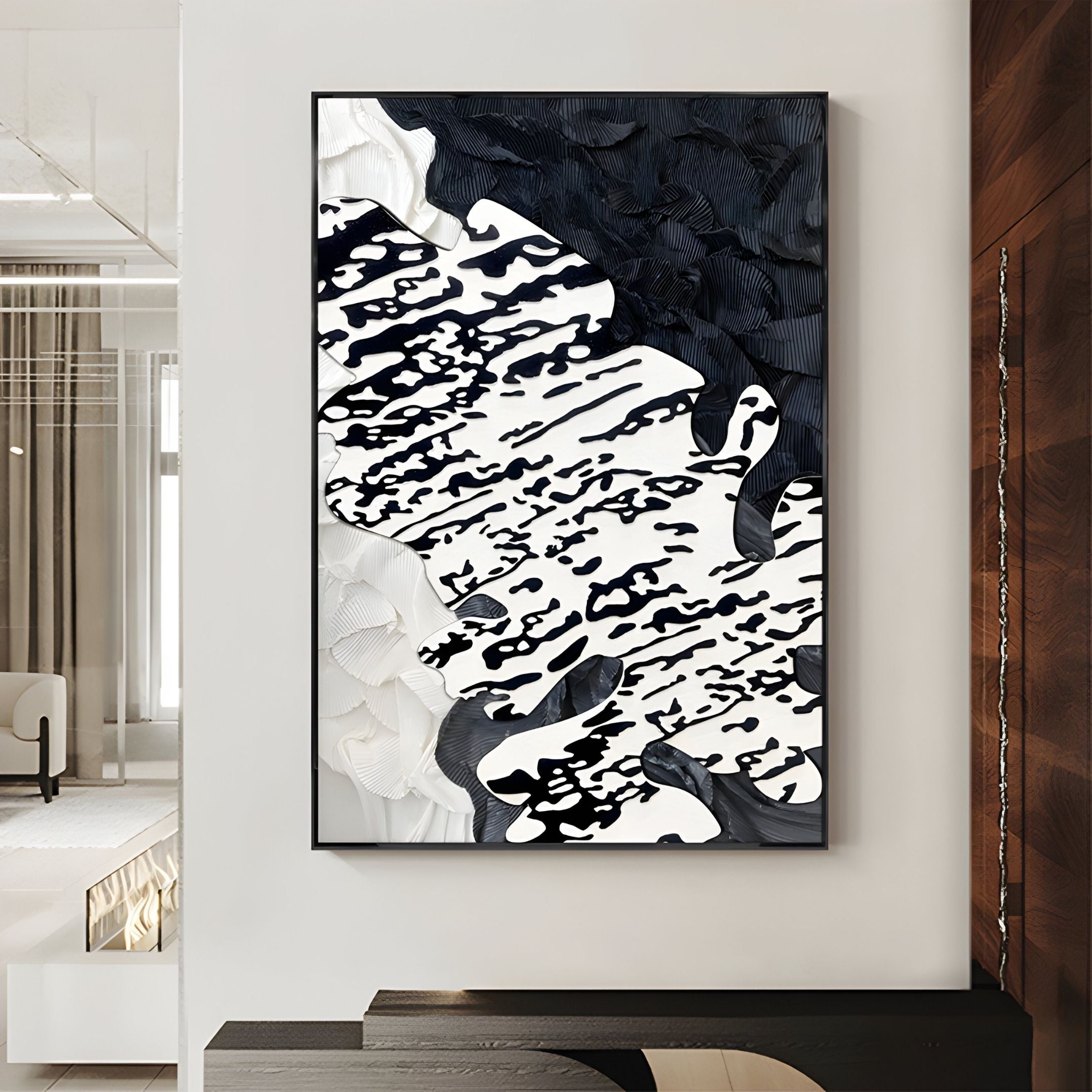 The Nivoria II Black & White Textured Abstract 3D Wall Art by Giant Sculptures hangs above a minimalist console, bringing bold, organic patterns and contemporary textured appeal to the room.