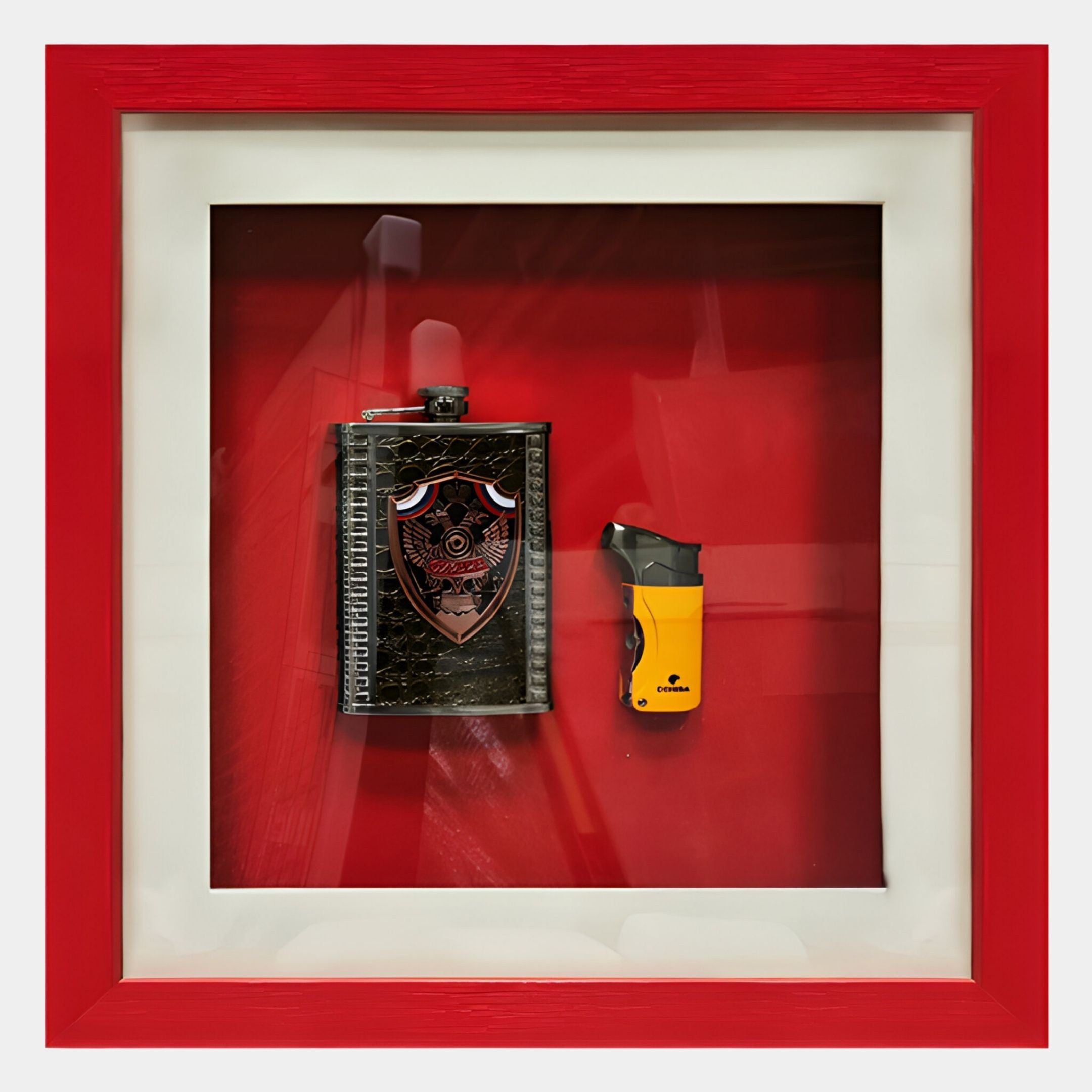 The Cavendro Flask & Butane Lighter Framed Wall Art by Giant Sculptures features both items mounted on a vivid red background in a bold red and white frame—a striking piece of contemporary décor.