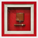 The Cavendro Brown Flask & Cigar Framed Wall Art by Giant Sculptures features a brown flask and cigar in a shadow box with a red background and red-and-white frame, creating striking wall art for your space.