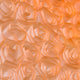 The Lumora Amber Orange Acrylic Framed 3D Paper Wall Art by Giant Sculptures showcases delicate, handmade paper roses in peach tones arranged closely for a textured floral pattern, all set within a sleek acrylic frame.